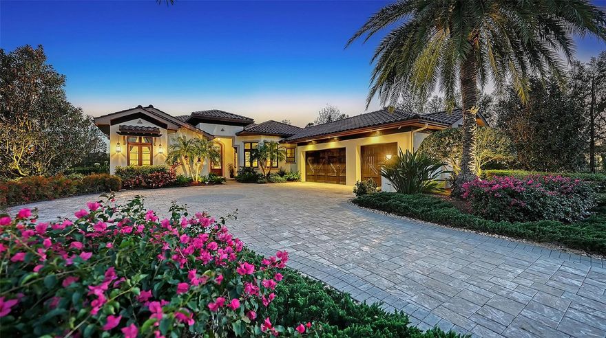 This exceptional former Westwater model home in The Lake Club is set on over 2/3 acre and showcases expert craftsmanship, luxury finishes, and a premier lakefront setting with southern exposure and lush gardens. Designed to maximize natural light and capture stunning garden and water views, this nearly 3,800-square-foot, Green-Certified residence offers a four-bedroom layout, including a private casita with a king-sized bedroom, living room, and full bath. An en suite office offers the perfect work-at-home space or can easily serve as a 5th bedroom. The professional kitchen is both elegant and functional, featuring onyx countertops, an oversized island, solid wood cabinetry, a Thermador cooktop, large wine refrigerator, double ovens, and a built-in espresso and coffee station." The living room is warm and inviting with a stacked stone gas fireplace, volume ceilings, and custom wood beams, while the primary suite offers a private patio and is a true retreat with onyx counters, a garden tub, and both indoor and outdoor showers. Walls of windows and glass doors seamlessly connect the indoor and outdoor living spaces, leading to a lanai and outdoor kitchen—shared with the casita—featuring Viking appliances and a motorized screen that can enclose the space or open it to the saltwater pool, built-in gas fire pit, and colorful gardens. Yard is fenced in. Residents of The Lake Club enjoy guard-gated security, a vibrant clubhouse, restaurant/bar, two resort pools, fitness, sports courts, fishing, and scenic trails. Situated in Lakewood Ranch, the nation’s top-selling multi-generational community, this home is just moments from world-class dining, shopping, top-rated schools, and Gulf Coast beaches.