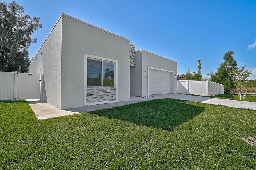 Stunning 2025-Built Modern Home – Energy Efficient & Hurricane Ready
Discover cutting-edge design and peace of mind in this newly constructed modern custom home featuring a sleek flat roof engineered for durability, enhanced wind resistance, and long-lasting performance. Located in a X flood zone, this residence is equipped with HURRICANE RATED WINDOWS, providing superior protection and energy efficiency. This home also features a french drain system designed to efficiently redirect groundwater and prevent flooding, ensuring a dry foundation and well-drained landscaping year-round.

Step inside to soaring 10-foot ceilings, striking 9-foot double front doors, and elegant custom modern lighting throughout. The open-concept living area showcases luxury vinyl flooring and a spacious chef-inspired kitchen with quartz countertops, a large island, walk-in pantry, and upscale stainless steel appliances—including a hood vent above the stove. A new washer and dryer are also included for added convenience.

The thoughtfully designed split floor plan offers 3 bedrooms and 2 bathrooms, featuring double sinks in both baths. The guest bath includes a large soaking tub, while the primary suite boasts a walk-in closet, large walk-in shower, and contemporary finishes. You’ll love the ample storage found throughout the home.

Enjoy Florida indoor-outdoor living on the large screened-in lanai and benefit from an oversized, finished 2-car garage. The property is fully fenced with a 6-foot vinyl privacy fence and features a sprinkler system with fresh sod in both front and back yards. Nearby Warm Mineral Springs with its year around 85 F water offers a therapeutic, relaxing experience.

A standout upgrade is the whole-house reverse osmosis water system—dual membrane filtration removes salt and chlorine prior to entry into the home, producing up to 4,000 gallons of purified water per day.

Move-in ready with modern comforts, storm security, and elevated style—this is the home you’ve been waiting for!