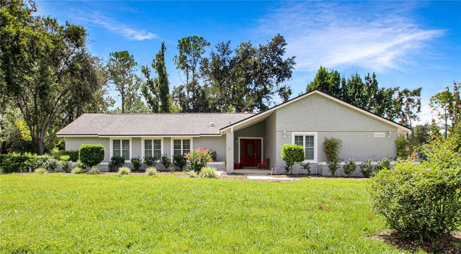 One or more photo(s) has been virtually staged. Beautifully situated on a one-acre corner lot with no HOA, this 5-bedroom, 3-bath home offers the perfect blend of comfort and convenience. Inside, you’ll find a spacious split floor plan featuring a remodeled bathroom, a bright and open kitchen, and a cozy wood-burning fireplace. Step outside to enjoy the sparkling screened pool, ideal for entertaining or relaxing in your private backyard retreat. Located in an area known for its top-rated schools, this property combines space, style, and an unbeatable location.