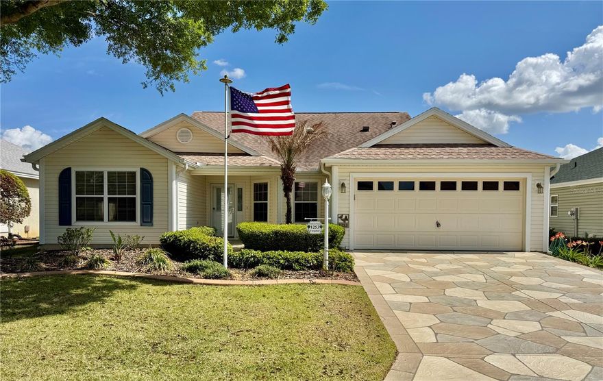 This prestine 3/2 Camellia Designer (like a Gardenia) is located in The Village of Liberty Park. As you drive up, you will notice the American Flag in the front yard, the great curb appeal and the painted driveway and walkway. As you enter the home, you will notice the volume ceilings and laminate flooring in the living room and dining room and ceramic tile in the kitchen and wet areas. The primary bedroom has laminate flooring and the 2 guest rooms have carpet. The third bedroom has a murphy bed but does not have a closet. The kitchen has a white range, dishwasher and microwave but the fridge is stainless. There is also a gas range, granite countertops and tiled backsplash. The dining room has a built-in buffet with a granite countertop. There are solar tubes in the kitchen and living room. The living room looks out through the glass sliders onto the screened lanai which is also painted like the driveway. The lanai is stretched 2 feet to the rear and the shades and landscaping gives lots of privacy. The primary bedroom has dual walk-in closets. There is sliders from the primary bedroom to the lanai. The primary bathroom has dual sinks and a step-in shower. The laundry is located inside the home with extra cabinets and a utility sink, the washer and dryer are included. There is a 2 car garage and the water filtration system is included AS-IS. The garage also has pull down stairs and raised trusses in the attic for storage. Centrally located in The Village of Liberty Park close to pools, restaurants, golf courses, recreation centers, shopping and entertainment. Roof 2021, HVAC 2016, Water Heater is original. Taxes $2,306.47, Maint $401.34, Fire $320.71, Bond Payment $854.81 Annually and the Bond Balance is $5,153.14.