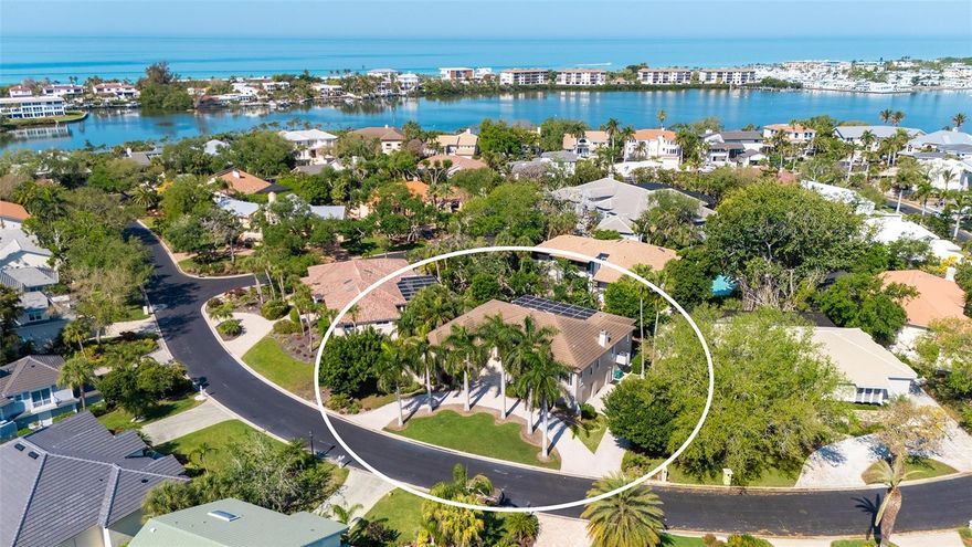 Welcome to The Bayou section of beautiful Bay Isles. Tucked away from the hustle and bustle of daily life, this double-gated community, a collection of 126 homes, is the perfect place to be on Longboat Key. The pavered front circular drive delivers you to the elevated double-door entrance. Step inside and prepare to be delighted by the neutral palate throughout and an abundance of natural light. Living is easy in this updated three-bedroom home which includes high ceilings and many tasteful architectural details. Three full baths and one-half bath, a dedicated office adjacent to the primary bedroom, a large formal dining room, separate breakfast room, classy cabinet-filled kitchen with new granite counters and a 9 ft island (seats 6). The kitchen is open to a spacious great room featuring vaulted ceilings, recessed lighting, built-in surround sound and a natural gas fireplace. This step-saving layout includes a main level laundry room as well. The primary bedroom has a new primary bath with a dual control sizeable shower, a walk-in custom closet, and direct access to the heated pool and spa just outside. Every bedroom has an en-suite full bath including the one that has direct pool deck access. Three sets of sliding glass doors open to the outdoor kitchen, pool and spa, all raised to be on the same living level. This main feature, having all living space elevated well above sea level is a bonus. An extremely large non-conforming space on ground level is ideal for multiple cars and/or boat storage, plus an air-conditioned space for a workshop or weight room if desired. There is a brand- new Trane A/C system (2026) as well as a new gas pool heater (2025) With too many fine features to list, this home is a must see. Ownership includes membership into the Bay Isles Beach Club, your private spot on the white sands of the Gulf of Mexico. Also, Longboat Key Golf and Tennis Club membership is available separately. Take a short drive to shopping and dining at the famous St Armands Circle and Downtown Sarasota. Magnificent!