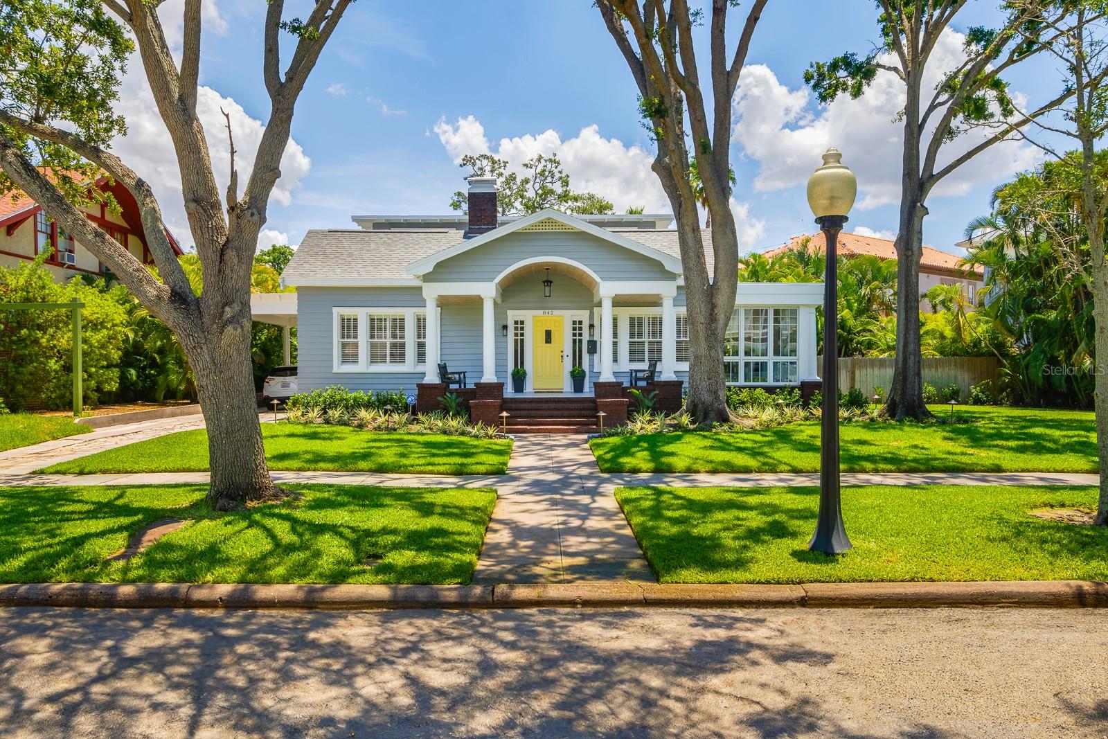 Charming Elegance in Historic Hyde Park and just steps from the scenic Bayshore waterfront, this timeless residence blends classic charm with modern luxury. Situated on a large corner lot, the home welcomes you with gleaming hardwood floors, a grand living room adorned with crown molding, and a cozy wood-burning fireplace. The expansive dining room is ideal for hosting elegant dinners and gatherings. The chef’s kitchen is a true showstopper—featuring a Wolf gas range, SubZero refrigerator, quartz countertops, and a generous center island perfect for entertaining. The warm and inviting study with a gas fireplace and built-in shelving offers the perfect retreat for work or relaxation. Enjoy serene Bayshore water views from the all-glass Florida room with slate flooring. A large laundry room adds everyday convenience, while a full-size guest suite with en-suite bath on the first floor offers privacy and comfort. Upstairs, the owner’s suite boasts a luxurious en-suite bath and a spacious walk-in closet. A third well-appointed bedroom sits near a charming vintage-style hallway bath. (Main house features 3BR 3.5BA at 3,267SF plus the 1BR-1BA cottage at 380SF)The oversized one-car garage includes a private guest apartment above—ideal for visitors or additional income potential. All this, just a short stroll to the boutiques and cafés of Hyde Park Village, and a quick bike ride to Downtown Tampa and the Riverwalk. Virtual Matterport Tour: https://my.matterport.com/show/?m=2YeJgEC5q1n&mls=1