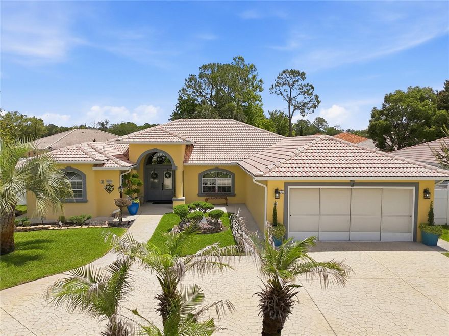 Welcome to 1 of only 3 Ana Paula Models ever built in Palm Coast by World Class Homes of NE Florida. It blends timeless Mediterranean-inspired architecture with quality craftsmanship and thoughtful design, this custom-built 3-bedroom, 3-bath home stands apart from today’s typical inventory. From the stamped circular driveway and elegant front elevation to the architectural ceiling details and ambient lighting, the home immediately delivers a sense of character and attention to detail.  Designed for both comfortable everyday living and effortless entertaining, the open split floor plan offers multiple living and dining spaces, wood-look LVP flooring and tile throughout, a stylish electric fireplace, and seamless indoor/outdoor flow. The kitchen was designed to be both beautiful and functional, featuring extensive KraftMaid cabinetry, granite countertops, stainless appliances, farmhouse sink, breakfast bar, coffee and wine station with built-in wine fridge, pull-out shelving, deep storage drawers, and built-in spice rack.  Pocket sliders open to an expansive 515 sq. ft. covered and tiled lanai overlooking the screened saltwater pool and private backyard setting. The lanai also features a convenient private pool bath, creating an ideal setup for outdoor entertaining and poolside living. Additional outdoor features include a paver fire pit area, mature landscaping, full fencing, and storage shed. A truly distinctive Palm Coast home that feels custom in every sense of the word.