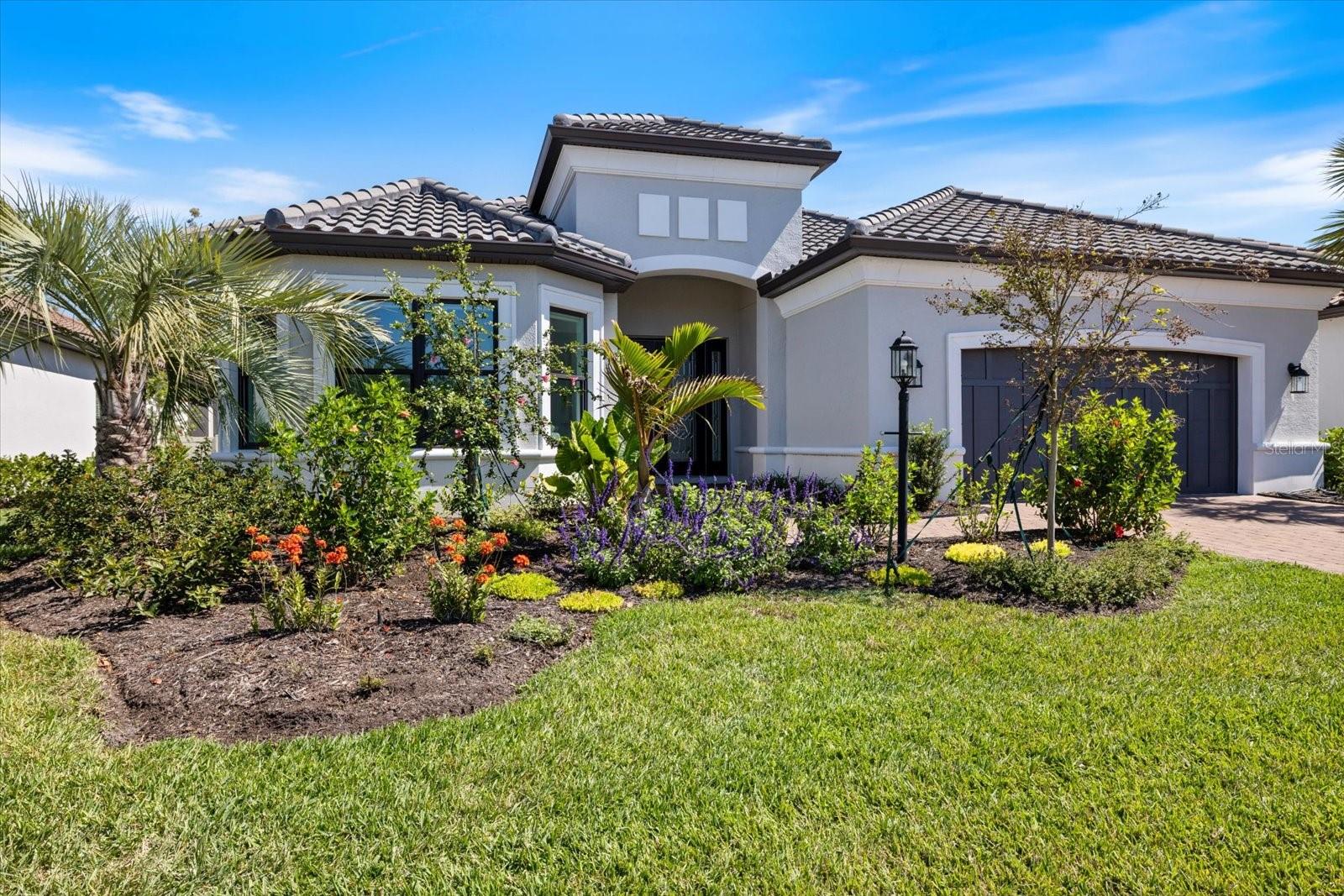 NON GOLF DEEDED. THIS HOME IS LOCATED IN THE MINIMAL RISK X FLOOD ZONE. EQUIPPED WITH IMPACT GLASS THROUGHOUT, STORM SMART SCREENS AND A FULL HOUSE GENERATOR
Welcome to your modern haven at Esplanade at Azario, where style seamlessly blends with functionality in this sleek 3-bedroom, 3-bathroom home with a den. Enhanced with nearly $300,000 in post-construction upgrades, this 3,072-square-foot residence is perfect for those who appreciate contemporary elegance.
The landscaping features underground piping on both sides to efficiently manage rainwater.
Step inside to a bright, open space where chic tile floors and recessed lighting set a modern tone. The oversized great room flows effortlessly into the dining area, creating an ideal space for both relaxation and entertaining.
The kitchen is a culinary enthusiast's dream, featuring a spacious island with premium quartz countertops, a walk-in pantry, and an extended area with a 44-bottle wine cooler. Outfitted with stainless steel appliances, including a gas stove and range hood, this kitchen is ready for everything from casual breakfasts to gourmet dinners. Pocket sliding doors and stylish pendant lights add an extra layer of sophistication.
The primary bedroom is a luxurious retreat, complete with a bay area perfect for a cozy sitting space. The ensuite bath offers an oversized walk-in shower with dual shower heads, dual sinks, and a vanity. The master closet is impressively large, providing ample storage space.
Step outside to your private oasis, featuring an oversized saltwater pool, clear view screening, and a travertine deck. The extended covered lanai offers a serene spot to enjoy the tranquil preserve views for added privacy.
This home also includes two additional bedrooms, one of which is ensuite, and an oversized laundry room with cabinets and a sink. Additional features include a Central Vac, Culligan water system, recirculating pump for reclaimed water, electric for a car charger in the garage, smart home technology, designer lighting and fans, crown molding, tray ceilings, gutters, and room-darkening shades.
Living in Esplanade at Azario grants you access to top-notch amenities. Enjoy the clubhouse, pickleball and tennis courts, gym, and putting green. The state-of-the-art Culinary Center offers additional dining and entertainment options. Unwind at the spa, take a dip in the resort-style pool, or savor a drink at the bar. An activities director is available to help you make the most of the community's offerings. This home is not just a place to live; it's a lifestyle waiting to be embraced.
3D tour of home is in links: https://www.zillow.com/view-imx/6016e25a-d7cb-4e7c-8bc5-086d693da0ac?setAttribution=mls&wl=true&initialViewType=pano&utm_source=dashboard