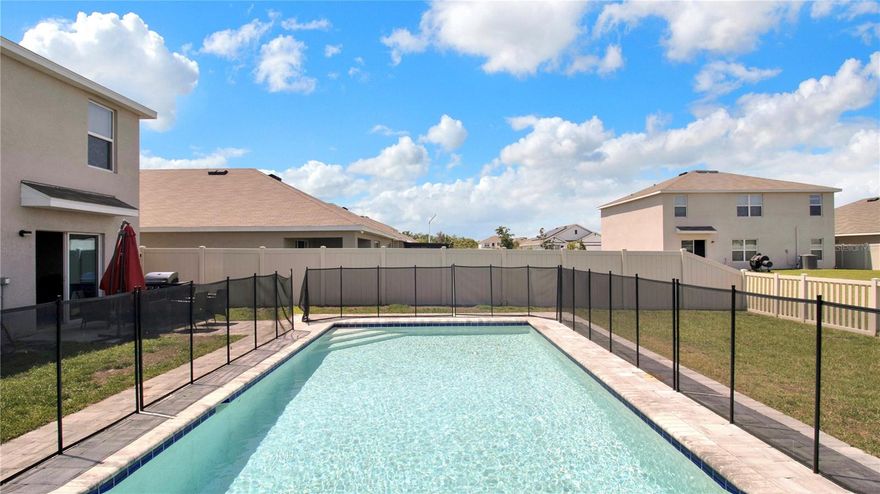 Welcome to this spacious and modern two-story home in the sought-after Creek Preserve community. Built in 2022 and offering over 2,600 square feet, this beautifully designed residence features five bedrooms and three full bathrooms, giving you all the comfort and room your lifestyle needs.

The main level offers a bright, open layout that seamlessly blends the living room, dining area, and kitchen. Sunlight fills the space, creating a warm and welcoming atmosphere. The kitchen stands out with its stainless-steel appliances, ample cabinetry, and a large center island perfect for cooking, hosting, or gathering with family and friends. A convenient first-floor bedroom and full bathroom make hosting guests or multi-generational living effortless.

Upstairs, the primary suite provides a relaxing retreat with a spacious walk-in closet and private en-suite bathroom. Three additional bedrooms surround a generous loft area—ideal for a play zone, home office, or second lounge area. With thoughtful storage and an efficient layout, the home feels comfortable, functional, and ready for everyday living.

Step outside and enjoy your own private oasis. The backyard features a beautiful in-ground pool, perfect for cooling off or relaxing on warm Florida days. The pool is secured by a child-safe fence, offering added peace of mind for families with little ones. The outdoor space is ideal for weekend fun, barbecues, and quiet evenings by the water. A two-car garage and well-sized lot complete the setting.

Nestled in a friendly community known for its sidewalks, green spaces, and easy access to shopping and dining, this home also sits close to US-301 and I-75 for smooth commuting. With its modern interior, family-friendly outdoor features, and resort-style backyard, this home is the perfect choice for anyone looking for comfort, style, and relaxation in Wimauma.