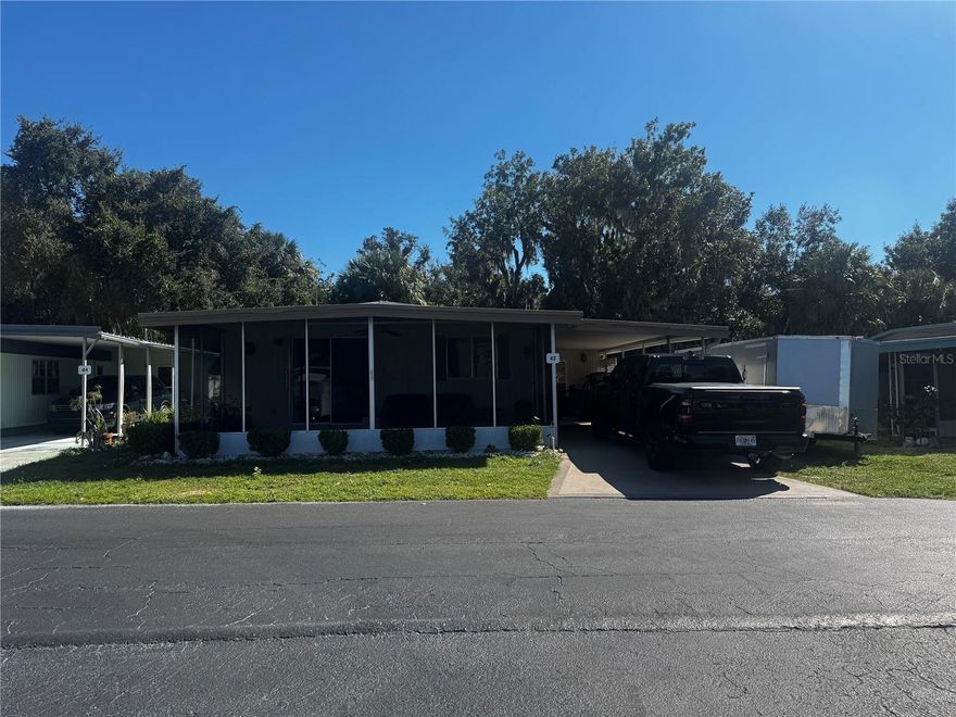 Beautifully renovated modular home with modern laminate flooring throughout, new kitchen cabinets, new countertops, washer/dryer in kitchen, and a carport with a finished and air conditioned garage! This home is also located just 7 properties from the lake and private boat launch, as well as the fishing pier, marina, and shuffleboard courts! This sale is for the mobile home only (no land included). The land is a lot lease (at $530/month) and includes lawn care and garbage. 55+ community.