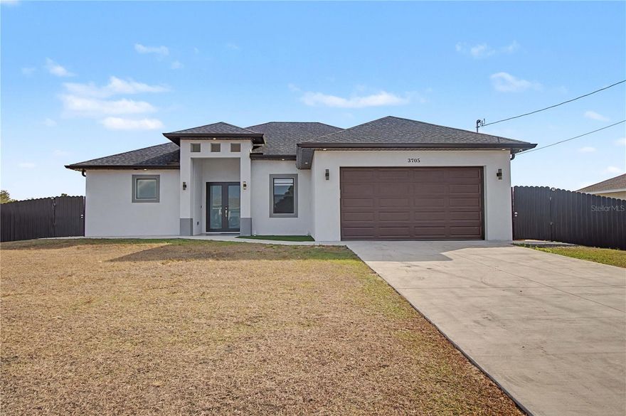 This well-appointed residence offers 3 BEDROOMS PLUS A DEN AND 2.5 BATHROOMS, set on a RARE HALF-ACRE LOT—the ONLY HALF-ACRE PARCEL IN THE AREA—providing exceptional outdoor space and privacy. The home features IMPACT WINDOWS AND DOORS THROUGHOUT and FULL TILE FLOORING, creating a clean, modern feel that’s both durable and low maintenance. Inside, the open layout flows effortlessly into an OVERSIZED LANAI, ideal for everyday living and entertaining. The exterior is where this property truly stands out, with a FULLY FENCED BACKYARD WITH METAL FENCING, ENTIRE BACKYARD LIGHTING, and a peaceful setting with the canal running along the side of the property, offering added openness and separation without sacrificing usability. An OUTDOOR KITCHEN enhances the outdoor living experience, while the PAVED BOAT CARPORT WITH PAVERS provides ideal covered storage for a boat, trailer, or additional vehicles. The property also features TWO SEPARATE ENTRANCES FROM THE MAIN ROAD, a CONCRETE DRIVEWAY, and ample room to add a POOL. This property offers a rare opportunity to enjoy space, flexibility, and privacy in Lehigh Acres. The BOAT IS ALSO AVAILABLE FOR PURCHASE, making this an excellent option for buyers seeking room to spread out and customize their lifestyle.