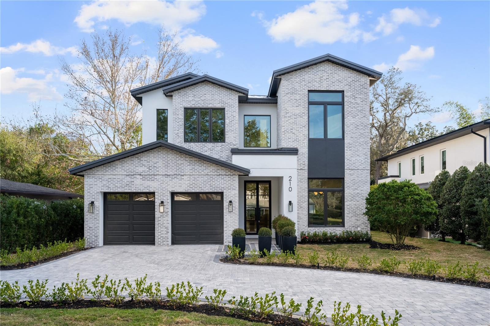 Exquisite Winter Park residence built by Davila Homes, where luxury meets functionality. This impressive home features 5 spacious bedrooms, 5.5 beautifully designed bathrooms, and a generous 4,188 square feet of meticulously crafted living space. As you step through the glass front doors, you’re immediately greeted by the grandeur of beautiful hardwood floors and the high ceilings. The chef-inspired kitchen boasts quartz countertops, custom cabinetry, and top-of-the-line Thermador Appliances, perfect for the chef in the family. The open-concept living, dining, and kitchen areas flow seamlessly, creating an inviting atmosphere for everyday living and entertaining. The primary bedroom suite offers a peaceful retreat with a separate sitting area and massive glass sliding doors with views of the pool and back yard. The spa bath features a wet room with a large walk-in shower and freestanding tub, there is also a spacious walk in closet, and dual vanities with custom cabinetry and quartz countertops. On the second floor you will find three additional bedrooms, each with its own private bathroom, and a massive bonus room with a secret hidden playroom for the little ones. Outside, the home continues to impress with a full covered lanai with retractable screen, ideal for relaxing and enjoying Florida’s beautiful weather. There is also a full summer kitchen, a sparkling pool with a hot tub, and ample backyard space with lush landscaping. Jump on your golf cart and within minutes you’re transported to Park Ave, with its amazing shops, fine dining, and everything else that Winter Park features. Schedule your private showing today and experience the epitome of luxury Winter Park living.
