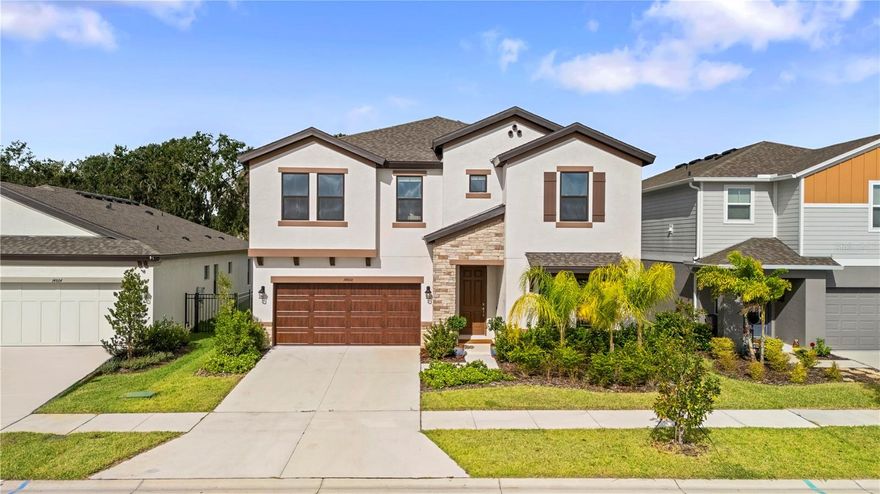 Welcome to 14868 Summer Branch Dr., Lithia, FL!
This stunning Pelican model by Homes by WestBay offers 5 bedrooms, 3 full bathrooms, and an inviting open-concept layout perfect for modern living.
Step inside to discover elegant Sonoma Linen cabinetry, Frost White MSI quartz countertops, and Polaris Plus luxury vinyl plank flooring throughout the main living areas. The open floor plan seamlessly connects the grand room, spacious kitchen, and bright café area—all overlooking the covered lanai, ideal for entertaining or relaxing with family.
On the first floor, you’ll find a secondary bedroom and full bathroom, perfect for guests or multigenerational living. Upstairs, a large loft provides versatile space for a movie room, playroom, or additional family lounge.
Tucked away at the rear of the home, the owner’s retreat offers a serene escape with a spa-inspired bathroom featuring a walk-in shower, oversized soaking tub, and generous walk-in closet. Two additional bedrooms and a full bath are located on the opposite side of the loft, providing privacy and comfort for everyone.
Sitting on a 0.14-acre lot, the spacious backyard is a blank canvas for your outdoor dreams—whether you envision a sparkling pool, summer kitchen, or relaxing garden retreat.
Hawkstone is a sought-after master-planned community featuring resort-style amenities, top-rated schools, and access to nearby nature preserves. Enjoy pet-friendly hiking trails at the 969-acre Triple Creek Nature Preserve, or try your hand at Triple Creek BMX, just a mile away. Conveniently located near US-301 and I-75, this home offers an easy commute to anywhere in the Tampa Bay area.
Why wait for new construction? Move into this 2024-built beauty today and start living the Hawkstone lifestyle!