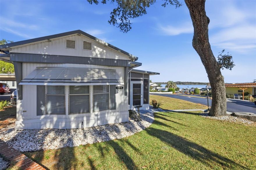 This home is located in the 55+ Resident Owned community of Griffwood. Being in a resident owned community, you can easily afford the low maintenance $181,00,,,(no lot rent) which also includes your water, sewer and trash pick on site manager, pool,  This home is situated on a corner lot at the top of the hill and has a great view of Lake Griffin, plus from the Screened lanai you can view also the rocket launches from Cape Canaveral. This home has two bedrooms, 1 large bathroom with a walk in shower.  The open floor plan is great for entertaining and having snacks at the dividing bar area.  The clubhouse, pool and game areas are located across the street from this home. (Card games, Billiards, Potlucks, Updated kitchen, Community Parties, Shuffleboard, New Years Eve entertainment, and lots more!).  The Central A/C & Heat Unit is just 2 years old. The Golf cart is included n the sale of the home.  Call to make an appointment today for a private viewing!