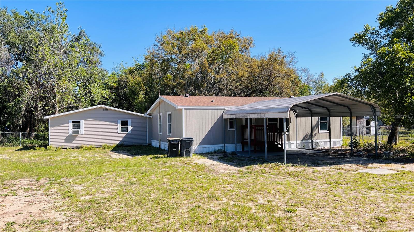 Fully Renovated DOUBLE WIDE with 2ND UNIT MOTHER-IN-LAW SUITE with additional full kitchen, bedroom and bathroom. Great for multi-generational families or two families. Separate entrances. This stunning home boasts two brand-new kitchens, new modern bathrooms, fresh flooring, vibrant paint, a new roof on primary home, brand new AC, and a new water heater—everything is updated and ready for you. Situated on half an acre, there’s endless potential for outdoor living, gardening, or creating your dream space. Enjoy peaceful evenings or morning coffee on the charming private covered back porch. 2-car carport. A must-see! (appliances to be installed before move-in). First month rent, last month rent and deposit are required for move in.