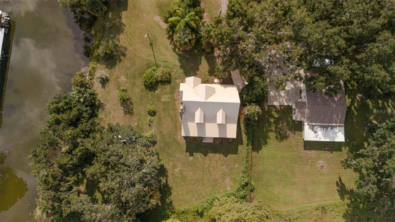 If you are looking to capture a piece of old Florida and want to live peacefully on eighty feet of lakefront on Lake Marion in this 2010
3 bedroom 2 1/2 bath lakefront home than look no further! It's a perfect fisherman's paradise with easy boat access next door. The home is priced below the current August 2025 appraisal. No HOA means total freedom for long term rentals and vacation rental. Enjoy mornings and evenings on the front porch with private and serene lake views. Cozy up to the wood burning stone fireplace as you watch the various local birds such as peacocks, bald eagles and osprey soar pass your expansive windows. The windows were upgraded with automatic and or manual hurricane shutters. The metal roof will add an extra layer of security and peace of mind during storm season while a tankless water heater that was newly installed in 2024 will keep the water temperatures perfectly regulated. Additionally a brand new well is currently being drilled and will be ready for the new owner. Downstairs the ensuite master bedroom with a whirlpool jet tub adds ease of access to the living areas in this meticulously built and maintained home.The kitchen has granite countertops and every appliance needed to cook efficiently. The dining room is large enough to gather family and friends for meals year around. Upstairs are two oversized storybook bedrooms with quaint dormers looking out onto Lake Marion. This home has also been freshly pressure washed, If you are looking to capture a piece of old Florida in a safe and inviting home, look no further!