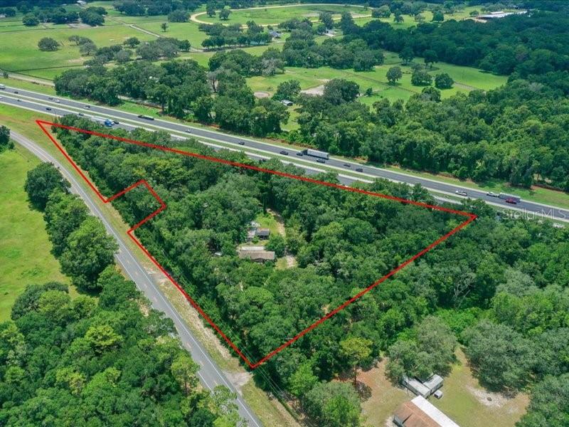 This property is great from a cost and location standpoint. Includes additional parcel 13740 County Road 475, Oxford FL 34484 that adds an additional acre taking total acreage to 6.7 Acres. This has a Manufactured home in need of repair and/or renovation that is a 3 bedroom 2 bathroom 1496sf manufactured home with a Screened lanai, wood deck, and a covered patio that is in need of repair or replacement. Has carports, workshop, sheds and a storm shelter. Being sold with this is another 3 bedroom 2 bathroom 960sf manufactured home sitting on additional acre. Both properties share a common well, However each has a separate septic. Package Deal.