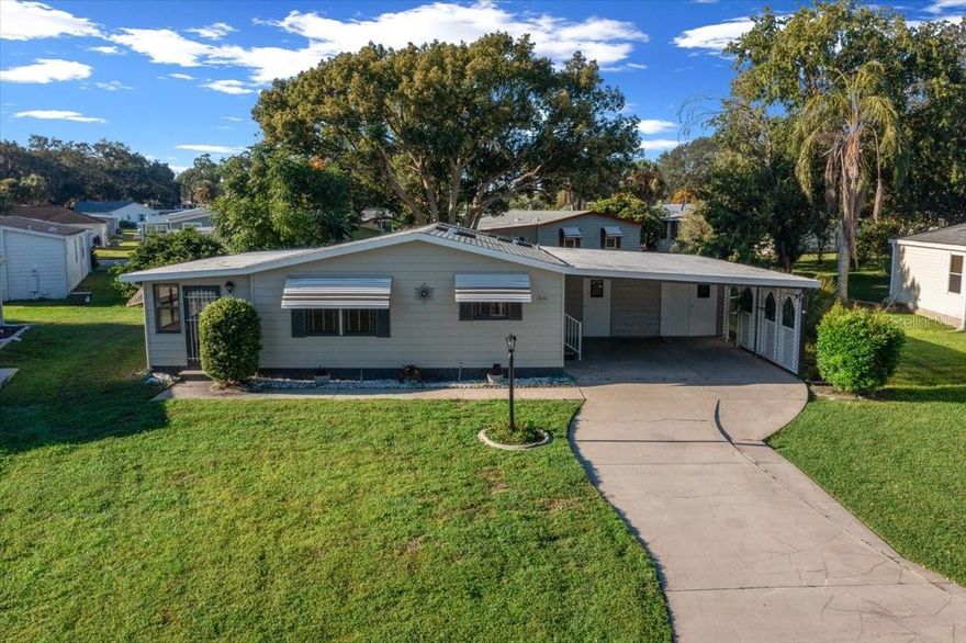 NO BOND! BEAUTIFULLY UPDATED~TURNKEY~ 2 bed/ 2 bath manufactured home in the HISTORIC Village of Orange Blossom—just minutes to Spanish Springs!

Welcome to this tastefully updated home offering comfort, style, and convenience in one of the most desirable areas of The Villages. Situated on a spacious lot with mature landscaping, this home delivers the charm of the historic side with modern upgrades throughout.

Step inside to find a bright and inviting layout featuring LUXURY VINYL PLANK flooring in the main living areas and FRESH CARPET in the bedrooms for added comfort. The beautifully renovated kitchen showcases WHITE QUARTZ countertops, WHITE CABINETRY, and a STYLISH TILE BACKSPLASH, creating a fresh and modern space perfect for cooking and entertaining.

The guest bathroom adds a fun pop of personality with its CHEERFUL COASTAL BLUE design, complete with a tub/shower combo, GRANITE countertops, and TILE BACKSPLASH. The spacious primary suite features DOUBLE DOOR entry, CEILING FAN, and a private en-suite bath with an UPDATED WALK-IN SHOWER, GRANITE countertops, and TILE BACKSPLASH.

Enjoy the best of Florida living with a versatile FLORIDA ROOM that seamlessly connects to both the living room and the lanai through GLASS SLIDERS, creating the perfect flow for relaxing or entertaining year-round.

Additional features include fresh interior and exterior paint, a DOUBLE CAR CARPORT, GOLF CART GARAGE, and a convenient laundry and storage area—ideal for everyday ease and extra functionality.

Located just a short golf cart ride to Spanish Springs Town Square, you’ll enjoy nightly entertainment, shopping, dining, and close proximity to Orange Blossom Hills Country Club, Hilltop Pool, and nearby golf courses and recreation centers.

This home offers the perfect combination of UPDATED STYLE, PRIME LOCATION, and NO BOND—making it an excellent choice for full-time living, a seasonal retreat, or investment opportunity. Be sure to watch the VIRTUAL TOUR and book your showing to see this beautiful move-in ready home today!!!