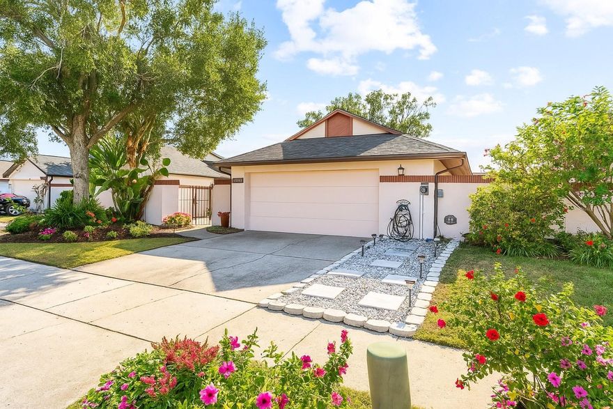 Welcome to this beautifully maintained MOVE-IN READY 2-bedroom, 2-bath home in the highly desirable area of  West Tampa. NO CDD and LOW HOA fees! With a NEW 2022 ROOF, NEW DISHWASHER and MICROWAVE, FRESH INTERIOR PAINT, a bright open layout, and a 2-CAR GARAGE with a NEWER ELECTRIC OPENER (2022), this home offers comfort, style, and effortless living. The spacious living room features VAULTED CEILINGS, ENGINEERED WOOD FLOORING, and a cozy wood-burning fireplace, an inviting space for relaxing or entertaining. The SPLIT FLOOR PLAN provides privacy, highlighted by a generous primary suite with DUAL SINKS, a tub/shower combo, and TWO CUSTOM-BUILT CLOSETS designed for exceptional organization. The kitchen stands out with ABUNDANT CABINET STORAGE, UPDATED APPLIANCES, and a LARGE CENTER ISLAND, rare for this neighborhood! A sunlit eat-in nook overlooks the private patio, creating the perfect spot for morning coffee or casual dining. An inside laundry room and additional storage add convenience to the thoughtful layout. Bayport Community offers easy access to everyday necessities, including parks, walking trails, restaurants, shopping, and Tampa International Airport. The property is also ideally situated near major highways and offers convenience to top-rated schools. With excellent affordability and a fantastic location, this is West Tampa living at its finest. Move-in ready and easy to show, schedule your visit today!