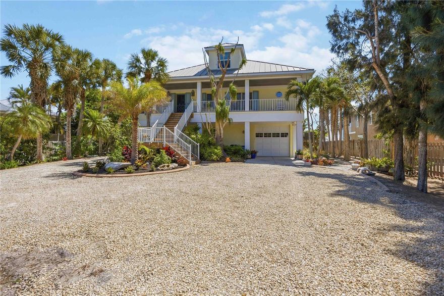 Picture pulling up your own palm-lined private drive on nearly an acre of premier Manasota Key waterfront. Right away, you feel that sense of arrival—this is your exclusive slice of paradise.
Step inside this custom-built 4-bedroom, 4-bath bayfront gem, and the first thing that hits you is the light. Soaring vaulted ceilings, bold angles, and walls of glass pour in natural sunshine, making every room feel open, bright, and effortlessly sophisticated. Front and rear balconies let you step out into the tropical breeze, surrounded by lush greenery and the gentle sounds of the area.
The heart of the home is the seamless open layout: a grand living room flooded with that gorgeous natural light, flowing right into the dining area, chef’s kitchen, and primary suite. Everything opens to a full-width screened balcony overlooking the expansive 40+ foot heated pool, brand-new deep-water dock (installed 2025), and tranquil Lemon Bay—perfect for hosting sunset gatherings or just relaxing year-round with the water right there.
You’ll love the chef’s kitchen—equipped with premium appliances, beautiful quartz countertops, and direct bay views so you never miss the action on the water. The spacious primary suite feels like a true retreat: step out to the screened porch for panoramic bay vistas, then unwind in the spa-like bath with dual vanities and a huge walk-in shower. There’s a flexible main-level guest bedroom that’s perfect as an office, studio, or extra space.
The home is thoughtfully elevated for coastal protection, with the state-of-the-art elevator (installed 2023) providing seamless access from the garage directly to the first (main living) floor. Upstairs, two mirrored guest suites offer soaring ceilings, charming dormer windows, and cozy window-seat alcoves—great private getaways for family or guests.
Outside, it’s pure resort living: an expansive 40+ foot heated pool with a full bath and outdoor shower, a private workshop for your hobbies or projects, and a backyard deck leading to your sandy shoreline—ideal for launching paddleboards, kayaks, or just kicking back barefoot. Best of all, you have private deeded beach access to the pristine Gulf of Mexico, so those sugar-sand beaches and turquoise waters are just steps away for ultimate convenience.
The oversized 4-car garage with tall ceilings and tons of built-in storage handles vehicles, an RV, boats, or toys—you name it.
And then there’s Lemon Bay itself: pristine, protected waters alive with playful bottlenose dolphins, graceful manatees, soaring brown pelicans, elegant herons and egrets, cormorants, and so much more. You’ll catch these moments right from your backyard—nature’s show, every day.
This rare bay-to-Gulf property on exclusive Manasota Key gives you total privacy, real distinction, and that seamless indoor-outdoor Florida lifestyle—with the added bonus of your own private path to the Gulf. It’s not just a house—it’s where breathtaking views and relaxed luxury come together to create something timeless for you and your family.