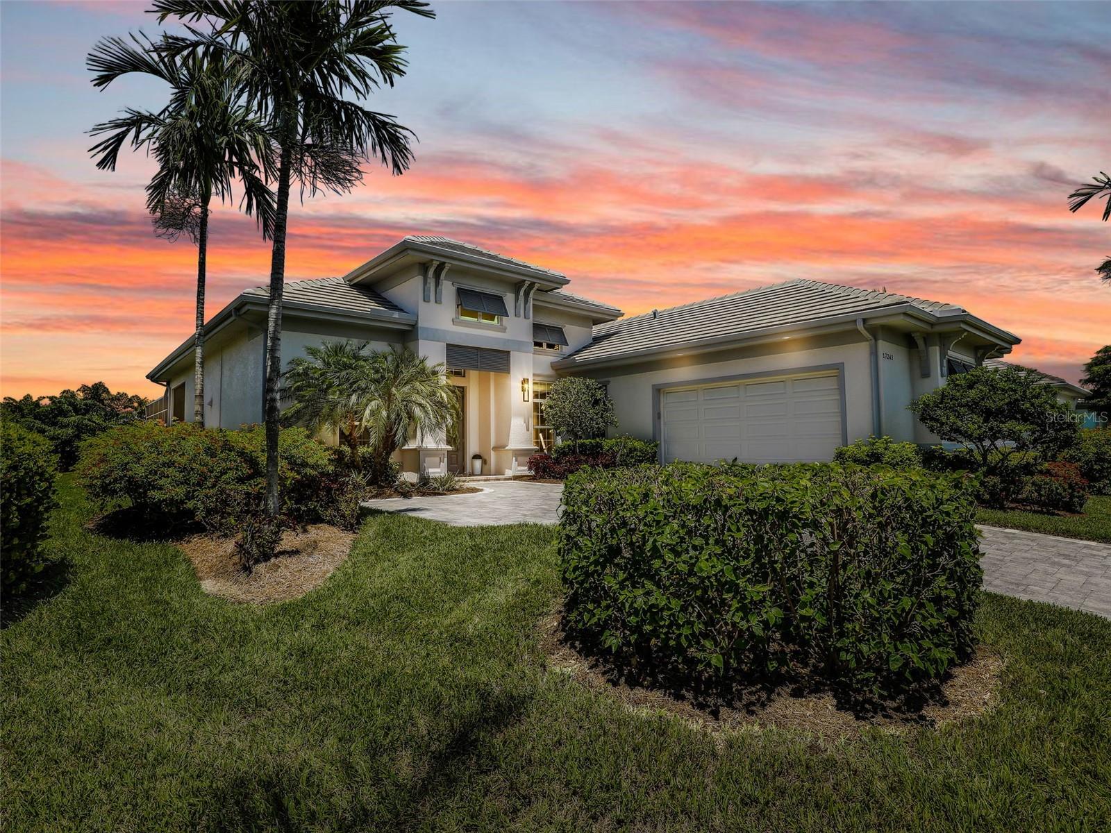 An exceptional opportunity in Hidden Harbor—one of Southwest Florida’s most exclusive boating communities—this meticulously maintained pool and spa home offers luxury living without the premium of a waterfront lot. Built in 2017 by award-winning Stock Development, this home features high-end finishes and quality craftsmanship, all set on a private, landscaped backyard that provides both serenity and value. Inside, enjoy 12-foot ceilings, elegant details, designer lighting, and neutral-tone porcelain tile in the main living areas. The chef’s kitchen is equipped with quartz countertops, a large island, natural gas cooktop, and an LG French Door Smart Refrigerator with Craft Ice. The floor plan includes three spacious bedrooms, a den with engineered hardwood flooring that can function as a fourth bedroom or office, and a flexible dining area that could be enclosed if desired. The primary suite offers peaceful views of the pool, dual custom walk-in closets, and a spa-like bath with soaking tub, walk-in shower, and raised dual vanity. One guest bedroom includes a built-in walk-in closet, and the other features a spacious closet with pocket doors. The guest bath offers a raised vanity and a tiled tub/shower combo. A large laundry room with a utility sink and built-in cabinetry adds convenience. Outdoor living is a highlight, with a screened lanai, gas-heated pool and spa, auto-fill system, one-touch automation, and brick paver deck. The covered space is pre-plumbed for a future outdoor kitchen and surrounded by lush landscaping for ultimate privacy. Additional features include impact windows and doors, a tile roof, and an epoxy-coated garage with custom storage, including motorized overhead racks and bike mounts. Hidden Harbor is a gated, 55-acre community with only 77 homes, offering a peaceful setting and fabulous location. Amenities include a clubhouse with kitchen and social space, resort-style pool, outdoor kitchen, fire pit, kayak launch, and community dock. Natural gas and all landscaping are included through the HOA, making this a low-maintenance, high-luxury lifestyle near RSW Airport, HealthPark, and Gulf Coast Medical Center.