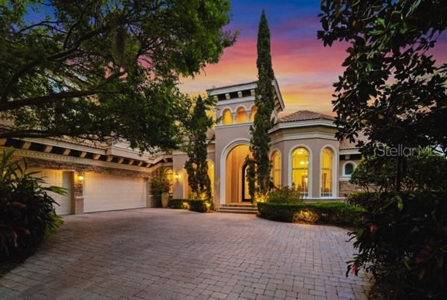 Experience elevated Florida living behind the private gates of the exclusive Highlands of Innisbrook Golf Resort, where this exceptional golf-front estate overlooks the 15th hole of the distinguished Island Course. Nestled beneath a canopy of mature oaks on a premium cul-de-sac homesite, this custom-built Marc Rutenberg residence offers timeless architecture, refined craftsmanship, and over 5,390 sq. ft. of thoughtfully designed living space. No flood insurance required. Built in 2006, this 6-bedroom estate features 4 full baths, 1 half bath, a private office, media room, bonus room with wet bar, and a wine cellar, and an oversized three-car garage with abundant storage. A full-house generator, home automation system, and security system provide modern convenience and peace of mind. Striking curb appeal welcomes you with a grand pavers' driveway and impressive 10-foot wrought iron and glass entry doors. Inside, expansive open living areas showcase elegant finishes and seamless indoor-outdoor flow. The chefs kitchen is a true showpiece, complete with custom floor-to-ceiling cabinetry, a generous walk-in butler's pantry, natural gas range, premium appliances, full-size wine refrigerator, R.O. system, breakfast bar, and separate casual dining area. The family room centers around a warm gas fireplace, ideal for gathering. The primary suite is a luxurious retreat featuring private French door access to the pool, spa-inspired bath with designer tile, oversized walk-in shower, soaking tub, dual marble-topped vanities, water closet, and spacious custom closets. Secondary bedrooms are equally well-appointed with walk-in closets and beautifully finished baths. Outdoor living rivals a five-star resort, offering sweeping golf and conservation views, a sparkling saltwater pool, gas fire pit, and a fully equipped outdoor kitchen with grill, sink, and refrigerator, perfect for entertaining year-round. Residents enjoy 24-hour guard-gated security and world-class amenities including four championship golf courses, tennis and pickleball courts, fitness center, full-service spa, multiple heated pools, dining venues, parks, trails, and more, all just minutes from Gulf beaches and area airports. An extraordinary opportunity to own a refined estate in one of Palm Harbor's most distinguished resort communities, where luxury, privacy, and lifestyle converge.