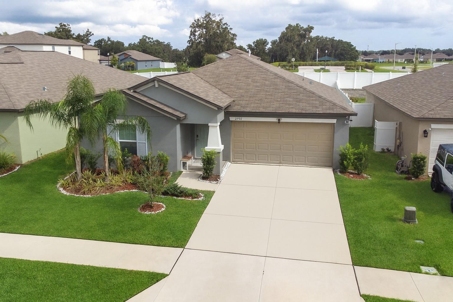 Welcome to this beautiful 3-bedroom, 2-bath home located in the desirable Wind Meadows South community. Built in 2023, this residence feels practically brand new but decorated with style and offers a modern, open-concept design perfect for everyday living and entertaining. The kitchen is a centerpiece, featuring a spacious center island, granite countertops, stainless steel appliances, a breakfast bar, and a convenient pantry. The open layout flows seamlessly into the large dining and living areas, creating an inviting space for family gatherings. You’ll love the easy-to-maintain tile flooring in the main living spaces, while the bedrooms are comfortably carpeted. The split-bedroom floor plan provides privacy, with the primary suite offering a generous walk-in closet and a private bath that includes dual sinks and a step-in shower. Additional highlights include a separate laundry room and a fenced in private backyard, ideal for cookouts and weekend relaxation. Located just minutes from Bartow Regional Medical Center and bordering Lakeland on Crews Lake Road, the community features amenities such as a pool, a dog park, and a playground, ensuring there's something for everyone. Call for a tour today!