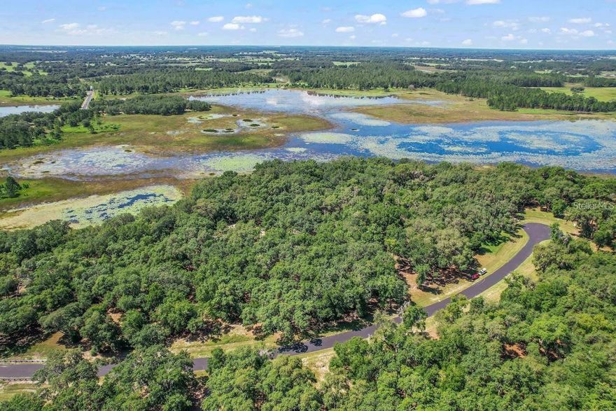 3.48 Lot Acres for this price! This won’t be on the market for long. It’s a gated community in Clearwater Reserve, one of central Florida’s best country estate gated communities. This lot has over 150,000 square feet, giving you ample space to build your dream home. You won’t have any rear neighbors on this waterfront homesite. There are no time requirements to build, and you can bring your own builder.
This community has acreage parcels for sale, and it’s perfect for those who have horses, enjoy fishing, or love water views. There are asphalt roads throughout the community, underground electric utilities, and fiber optic cable recently installed for high-speed internet.
The community features include gated access, a community dock, a fishing lake, a playground area, and two tennis courts. A minimum of 2,000 square feet of living area is required, but most homes in the community are much larger. There are also several new custom homes currently under construction. You absolutely must come and visit this place!