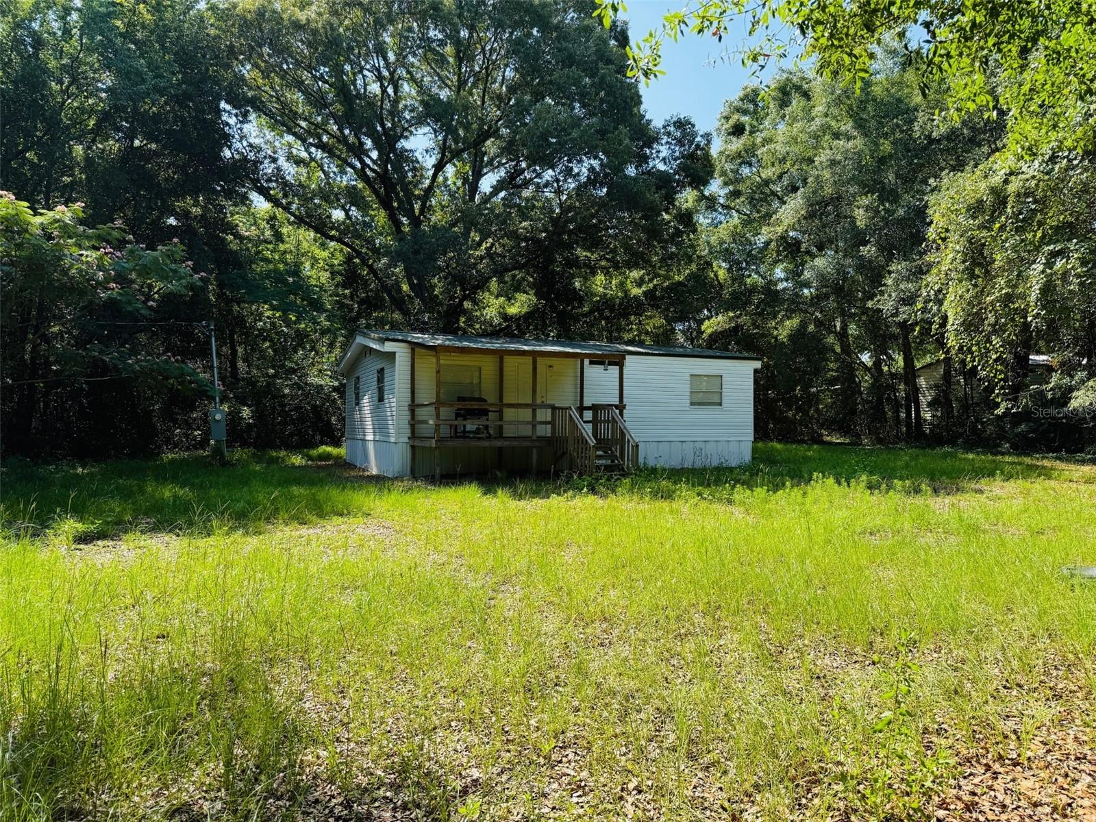Investor special! Cute 2Bed 2Bath Home on 2 acres (MOL) with a metal roof just off St Rd 47.