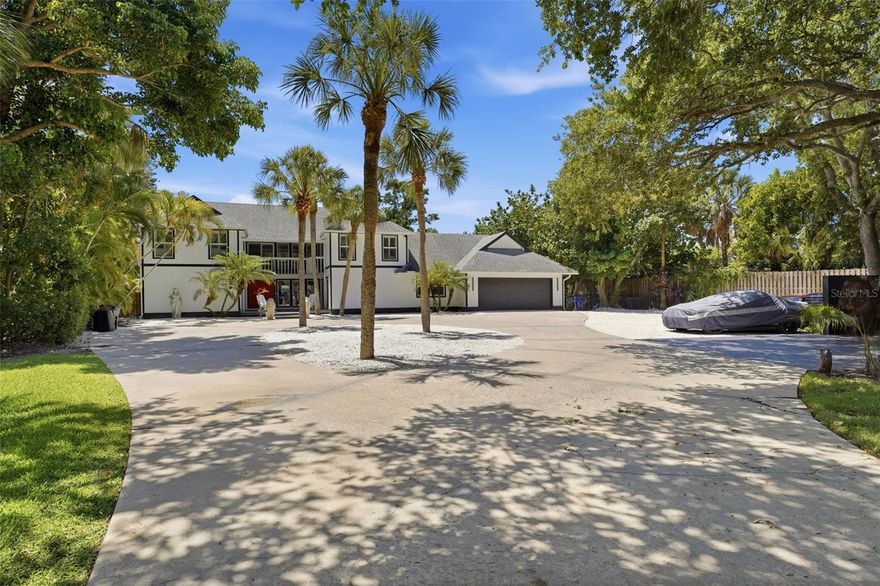Hidden behind an expansive 250-foot circular driveway, the residence is designed for those who appreciate luxury waterfront living and effortless entertaining. Offering approximately 3,500+ square feet, the home features 5 bedrooms, 2 bonus rooms, and dual primary suites, including a spacious main-level owner’s retreat and an additional upstairs suite ideal for guests or multigenerational living.
Inside, timeless elegance meets modern functionality with marble flooring, GE Café appliances, spray foam insulated walls for enhanced efficiency and sound reduction, and expansive living spaces filled with natural light and tranquil water views.
Recent improvements include three newer HVAC systems, a newer pool heater, major mechanical updates, and an oversized deep-water dock capable of accommodating larger vessels. Outdoor amenities create a true resort-style setting with a heated pool, private basketball court, lush tropical landscaping, and multiple areas for relaxation and entertaining.
The oversized waterfront lot is the true centerpiece of the property, providing remarkable privacy and unobstructed boating access with no waterway limitations — an increasingly rare offering on Siesta Key.
Conveniently located just minutes from Siesta Key Beach, marinas, fine dining, private clubs, and downtown Sarasota, this extraordinary property presents a rare opportunity to own a premier waterfront estate in one of Southwest Florida’s most desirable coastal destinations.