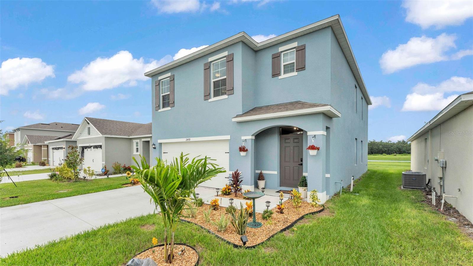 WELCOME HOME to this spacious 5-bedroom, 3-bathroom two-story home, built in 2024 and nestled in the highly desirable Eagle Hammock community in Eagle Lake, Florida. Offering 2,456 square feet of beautifully designed living space, this home features an open concept and combines comfort, style, and functionality.
At the heart of the home is an elegant kitchen, showcasing stainless steel appliances, a large island with seating, and a generous walk-in pantry. The kitchen flows seamlessly into the dining area and living room, creating the perfect space for gatherings and everyday living. Built with functionality, this home features a thoughtfully designed layout that includes a downstairs bedroom and full bathroom, perfect for accommodating guests or multigenerational living. On the second floor, you’ll find a spacious primary suite with an ensuite bathroom for added privacy, and a generous walk-in closet. A versatile loft on the second floor provides additional living space, and the conveniently located upstairs laundry room adds efficiency for everyday ease. Three additional bedrooms with walk-in closets are located on the second floor, and a third full bathroom with a dual-sink vanity provides ample space for everyone for comfort.
Step outside and enjoy peaceful evenings with relaxing pond views from your backyard. The Eagle Hammock community also features a community pool and a playground, making it a wonderful place to call home. Conveniently located just minutes from the Polk Parkway, commuting to Tampa and Orlando is easy and efficient. Don’t miss this opportunity to make this spectacular home yours. Schedule your private showing today!