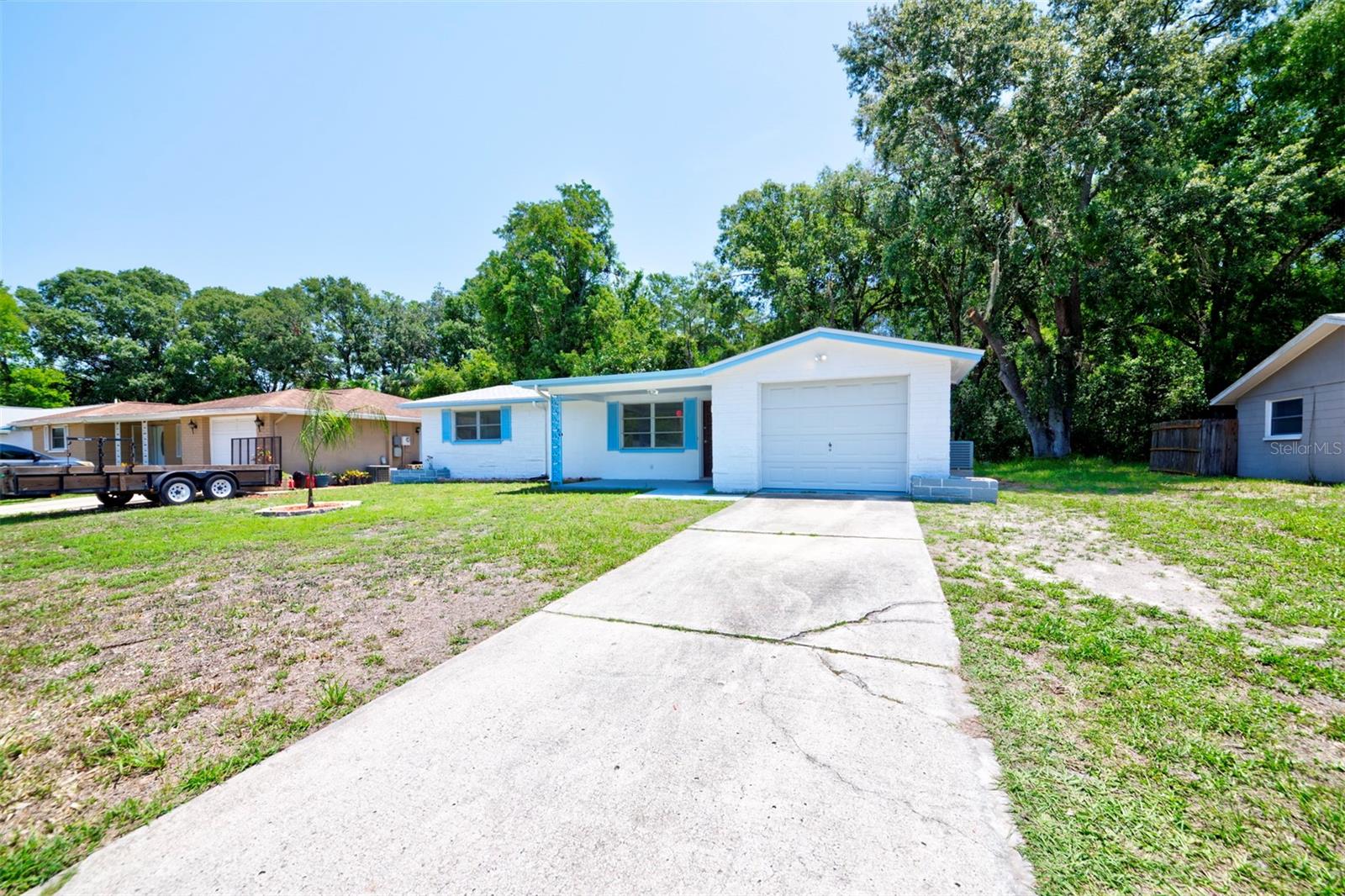 Welcome to 2628 Flintwood Drive, a charming 2 Bed 2 Bath home located in the heart of Holiday, Florida. This delightful single-family home boasts updates such as a NEW ROOF (2023) new kitchen with stainless steel appliances, and new electrical box (2023), and is located on a quiet dead-end street. As you approach the property, you'll immediately notice the well-maintained exterior and attractive curb appeal. The interior and exterior of the home was completely repainted in 2023. Situated on a spacious lot, this home boasts a beautifully landscaped front yard that creates a warm and welcoming ambiance. Step inside and be greeted by the spacious living area and sunroom, filled with natural light. Notice the beautiful marble window sills and ceramic tile floors throughout. The home is truly a blank slate, ready for you to make your mark! The kitchen is the true highlight of the home, boasting Brand NEW high end stainless steel appliances, ample cabinet space and attractive countertops. Whether you're preparing a gourmet meal or enjoying a quick snack, this kitchen has everything you need. The kitchen provides access to the oversized one-car garage, with plenty of space for your vehicle as well as storage. The property features two large bedrooms and two bathrooms. The spacious master suite is a tranquil haven with a bathroom and a walk-in closet. The additional bedroom is versatile and can be adapted to suit your needs, whether it be a home office, a guest room, or a hobby space. One of the best features of this home is the expansive backyard. The house has no rear neighbors and backs up to a nature conservation area. With privacy and plenty of room for outdoor activities the backyard is perfect for unwinding in the Florida sunshine. The screened-in back patio and wooden deck are great features offering unlimited indoor-outdoor entertaining. The possibilities are endless for you to create your own outdoor oasis! Located in the charming community of Holiday, this property offers convenient access to a variety of amenities and attractions. Nearby, you'll find great shopping centers, restaurants, nature parks, beaches, and attractions such as the Tarpon Springs Sponge Docks. This property has a central location near the Pasco Pinellas county line, ensuring you have everything you need within reach. Don't miss the opportunity to make 2628 Flintwood Drive your new home, and live the Florida dream. Perfect for first-time home buyers. Schedule a showing today before it's gone!