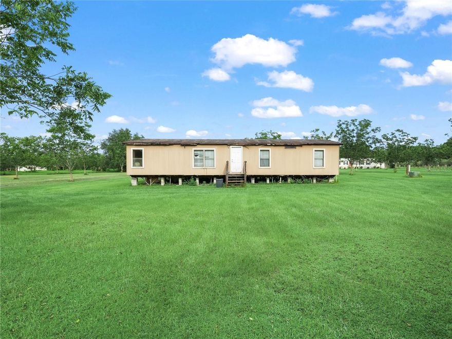 Peaceful Country Living on 2.44 Acres 
Discover the charm of rural Florida living on this high and dry 2.44-acre property nestled in the heart of Lithia. Lined with rows of mature pecan trees, this expansive lot offers a serene setting perfect for those seeking space, privacy, and a connection to nature.
The property features a 1986 double-wide mobile home with 1,512 square feet of living space. While the home needs work, it presents a great opportunity for a full remodel or replacement to create your ideal country retreat.
With 164 feet of frontage and 841 feet of depth, there’s plenty of room for farm animals, gardening, or building your dream home. Zoned for agricultural use, this property currently benefits from a greenbelt exemption on approximately 2.19 acres, helping reduce property taxes.
Located in a quiet, rural area yet still within reach of modern conveniences, this is the perfect spot for those looking to embrace a peaceful, country lifestyle.