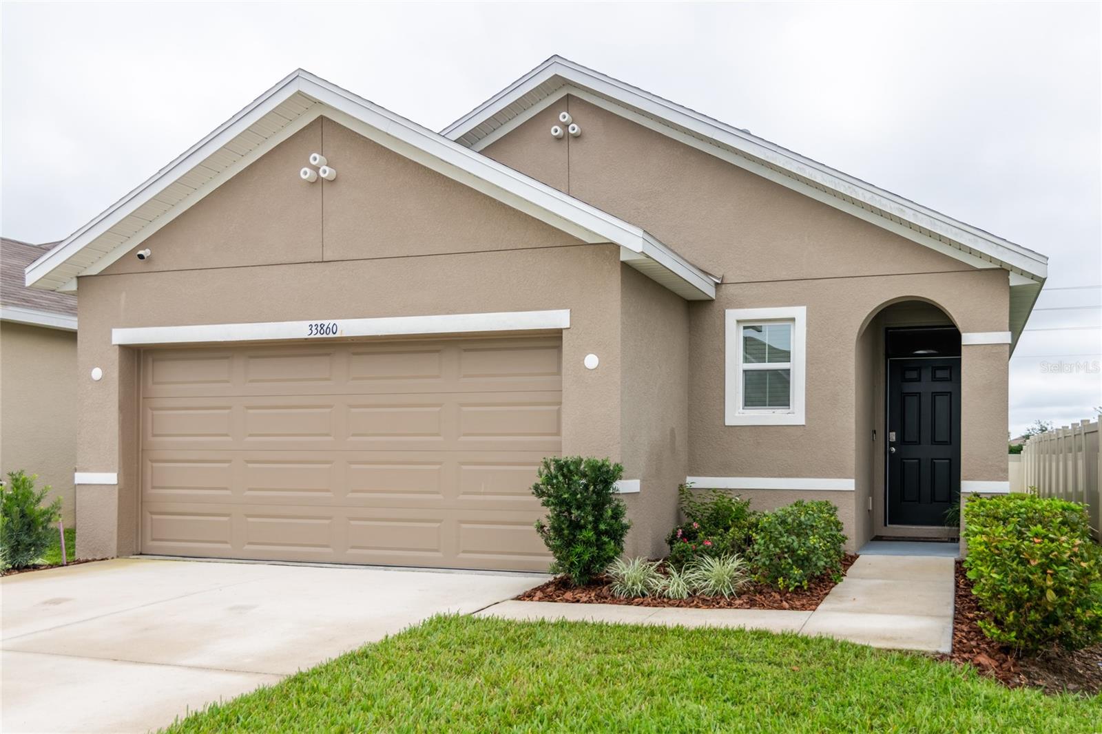 The Summerstone community has so much to admire, located in a prime location in the vibrant Wesley Chapel. 3 bedrooms, 2 full baths. This home is impeccable, like new. This home features an incredible open floor plan for the family. The whole home security system will give you peace of mind day or night. The community offers a resort-style pool, an open-air pavilion with a kitchen, a shaded tot lot, and an open play area with a half basketball court, enhancing the neighborhood's appeal. Conveniently located for easy commutes to work, shopping, and recreational activities, this home is a must-see. Being in the center of this growing city, you’ll be close to I-75 and the Tampa Premium Outlets, Main Event Entertainment, and just a few minutes from Wiregrass Mall and its many dining establishments. You’ll find several hospitals that serve the area such as St. Joseph and Advent Health. Summerstone features our D.R. Horton Express Elite series homes that include extended tile in the main living and dining area, granite countertops throughout, an under-mount kitchen sink, shower wall tile, a stainless-steel appliance package, and more. The Elite series lineup of homes also features our all concrete block construction.