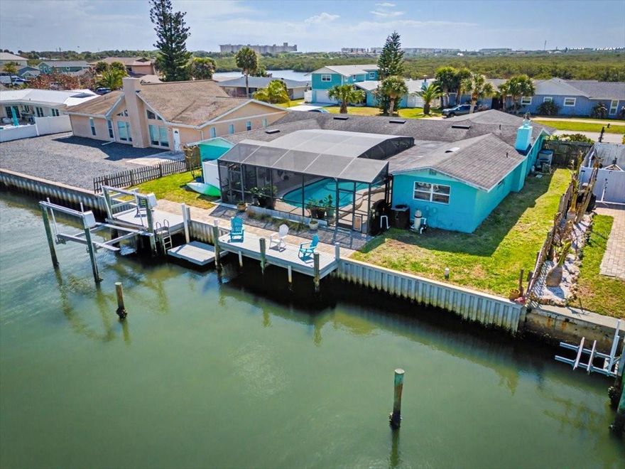 Welcome to your waterfront retreat in the sought-after Yacht Haven community of Ponce Inlet! Perfectly positioned on a quiet cul-de-sac, this 3-bedroom, 2-bath home offers 1,900+ square feet of comfortable coastal living with direct canal frontage and access to the Intracoastal Waterway. Step inside to find a spacious, light-filled layout featuring luxury vinyl, wood, and tile flooring, a cozy wood-burning fireplace, and multiple living areas including a family room and dedicated office space. The kitchen flows seamlessly into the dining and living areas—ideal for both everyday living and entertaining. Outdoors, enjoy true Florida living with a private screened-in pool, expansive deck, and your own dock complete with electric and lift—perfect for boating enthusiasts. Take advantage of easy access to the Halifax River, nearby marinas, and the beach just moments away. Additional highlights include a 2-car garage, central HVAC, stone countertops, walk-in closets, and a generously sized lot with private yard space. This home is fully handicap and wheelchair accessible. The primary bathroom has been beautifully remodeled with full wheelchair accessibility. Whether you're looking for a full-time residence or a coastal getaway, this home offers the best of waterfront living in one of Ponce Inlet’s most desirable locations.