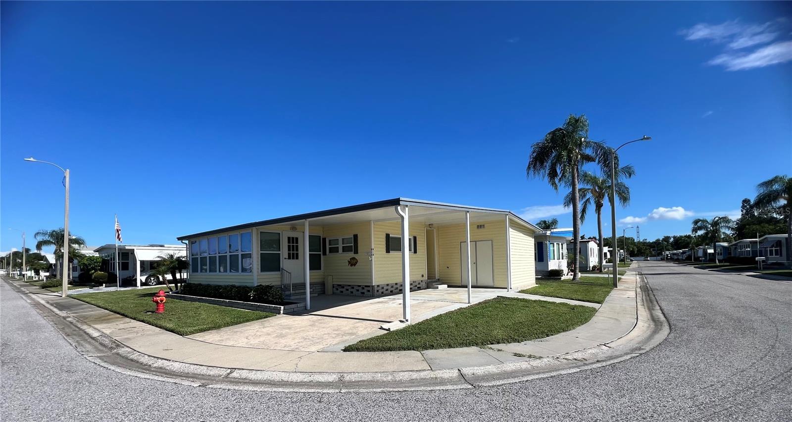 If you’re looking for the perfect open-concept home with a desirable split-bedroom floor plan, look no further. The 999 square footage of the home does NOT include the Florida room, with Florida room the home is close to 1200 sq ft of living space. This beautifully maintained residence offers a spacious layout with bedrooms located on opposite ends of the home, ensuring privacy and comfort for all. The open kitchen features a bar-top center island with room for two stools, ideal for casual dining or entertaining. Stylish laminate flooring runs throughout, while recent upgrades include a new A/C system installed in May 2021, enhanced with a larger return for improved efficiency, and newer double-pane windows throughout the home. Fully furnished and move-in ready, this home boasts two updated walk-in showers, modern-style laminate counters, and an inviting enclosed Florida room with a large sliding glass door—perfect for enjoying the space year-round. Natural light fills the home, creating a bright and cheerful atmosphere from morning to evening. The primary suite includes a spacious walk-in closet and en-suite bathroom, while the second bedroom is situated at the opposite end of the home with an adjacent bathroom, offering an ideal layout for guests or shared living. This property is turnkey and ready for use as a full-time residence, seasonal retreat, or rental opportunity. Nestled in the heart of Fairway Village, you'll have access to a wealth of amenities including a private 9-hole, par-3 golf course, a scenic 5-acre catch-and-release lake, two swimming pools with hot tubs, eight covered shuffleboard courts, and a brand-new 19,000+ sq. ft. clubhouse completed in 2022. The clubhouse features a 700-seat auditorium and ballroom, performance stage, commercial kitchen, fitness center, library, billiards and card rooms, meeting spaces, and complimentary Wi-Fi. With over 50 social events hosted annually, there’s always something to enjoy. The low monthly maintenance fee of just $401 (2025 rate) covers water, sewer, lawn care, pest control, curbside trash pickup, high-speed internet, and over 220 Spectrum TV channels. Optional golf memberships are available for $440/year plus tax, with affordable resident green fees for non-members. Homes with this floor plan are in high demand—don’t miss your chance. Schedule your showing today!