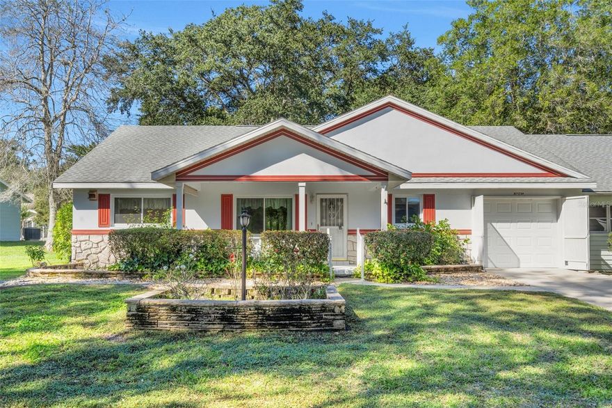 Located on a lovely tree lined street in the Friendship Colony of On Top of the World, this end unit villa has a covered front porch, a great layout, screened lanai and fenced in back yard.  This Birmingham model offers 1369 square feet, 2 bedrooms, 2 full baths, space to utilize as a great room, dining/breakfast area or working space, stainless steel kitchen appliances, extra storage in the kitchen, spacious walk-in closet in the primary bedroom, 2016 roof and 2017 electric water heater.  Interior features include engineered hardwood flooring in the kitchen, bedrooms and living areas.  The screened lanai offers endless possibilities.  Enjoy it for relaxing and entertaining, as a craft room or workshop.  Just off of the lanai is an enclosed area that can be used for golf cart parking.  This is a fantastic opportunity to bring your vision and make this villa your Florida lifestyle dream home!  We invite you to schedule a showing today!  So much to love about this home and community! On Top of the World is Ocala's desirable active 55+ community and a favorite of golf enthusiasts. Community amenities include 2 outdoor swimming pools & 1 indoor, 2 fitness centers, tennis, pickleball, bocce, shuffleboard, corn hole, horse shoes, billiards, archery range, library, dog parks, areas designated for remote control flying and race cars, restaurant and pub and over 100 clubs. HOA fee includes lawn care, trash/recycling, basic Spectrum Cable, roof repair, exterior painting every seven years, irrigation water, exterior maintenance and structure insurance, 24/7 monitored gates.