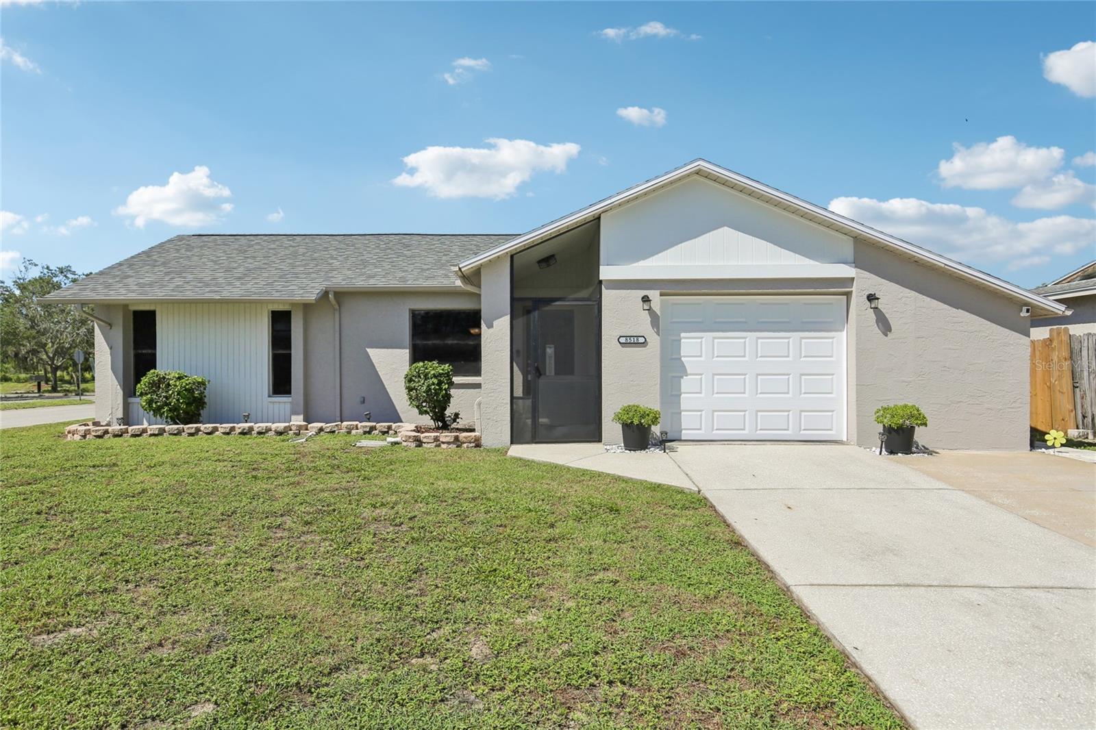 Welcome to this well-maintained 2-bedroom, 2-bath pool home with a 1-car garage, ideally located in Pasco. This home offers a bright, open floor plan with cathedral and vaulted ceilings that create a spacious and inviting atmosphere. The living areas feature updated porcelain tile flooring, while the bedrooms have wood laminate. Both bathrooms are finished with ceramic tile.
The family room includes a fireplace and sliding glass doors that lead to a large Florida room and a screened in-ground pool. The pool area is surrounded by cool deck surfacing, making it a great space for relaxing or entertaining.
The kitchen provides ample cabinet space, generous countertops, appliances, and a convenient breakfast bar for casual dining.
The oversized garage includes a workbench, A/C, and peel-and-stick wood-look flooring, making it ideal for use as a workshop. It also houses a matching black stainless steel Whirlpool washer and dryer set from October 2023, which will stay with the home. On the side of the garage, you'll find an attached storage shed with power for added convenience.
Located close to shopping, restaurants, the library, and public transportation, this home offers comfort, space, and a great Florida lifestyle. Schedule your visit today!