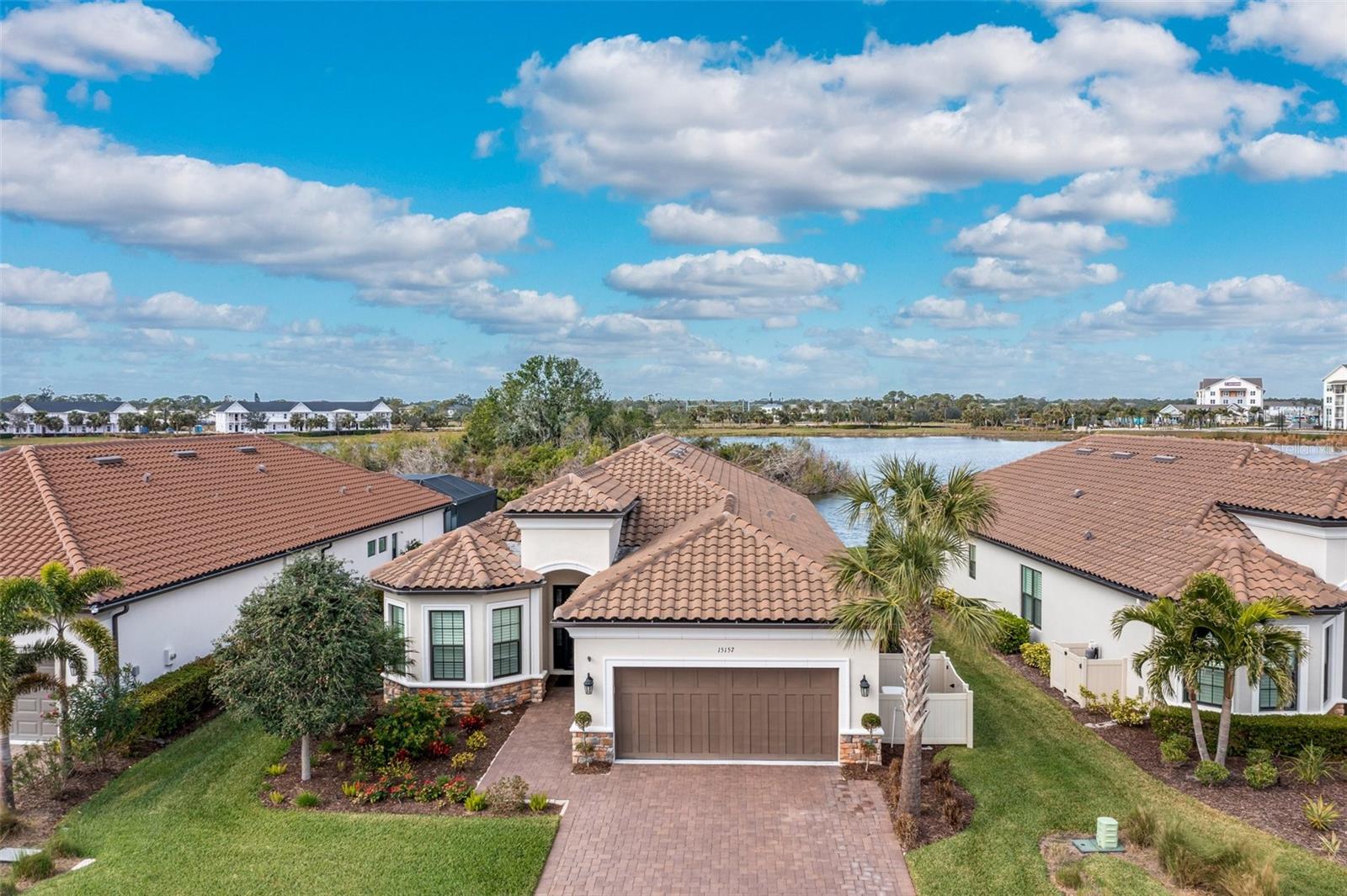 Welcome to this exceptional 2019-built lakefront home in the gated community of Bellacina by Casey Key, where nearly every upgrade has been selected to create a residence that is as functional as it is luxurious. Offering 3 bedrooms, 3 baths, and a private den, the home provides a perfect balance of open-concept living and flexible spaces. The kitchen is a true showpiece with an oversized island, custom cabinetry, premium stainless steel appliances including a convection oven and microwave, custom backsplash, and designer lighting, all overlooking the spacious great room with tray ceilings, crown molding, and expansive lake views. The primary suite is a private retreat featuring a spa-inspired bath with soaking tub, custom tile shower, upgraded fixtures, and a fully outfitted walk-in closet. Two additional bedrooms and the den offer comfort and versatility for guests, work, or hobbies, while the remodeled laundry adds convenience and style. Every detail of this home showcases thoughtful enhancements, from impact windows, upgraded flooring, cabinetry, and custom closets to sound and water purification systems, an on-demand water heater, and custom mirrors. The tandem garage includes built-in storage cabinets, while remote-controlled hurricane shutters and a whole-home Generac generator with transferable warranty provide peace of mind. Outdoor living is equally impressive, with a spacious lanai designed for year-round enjoyment featuring a full summer kitchen, cozy fireplace, and serene lake views that make every sunset unforgettable. Bellacina by Casey Key offers residents a resort-style lifestyle with a heated lagoon-style pool and spa, clubhouse with gathering rooms, fitness center, tennis, pickleball, bocce, dog park, and scenic walking trails. Ideally located just minutes from Nokomis Beach, the Legacy Trail, golf courses, shopping, dining, and the cultural hubs of Sarasota and Venice, this home delivers the best of Florida living. **THIS PROPERTY QUALIFIES FOR A 1% LENDER INCENTIVE IF USING PREFERRED LENDER. INQUIRE FOR MORE DETAILS.**