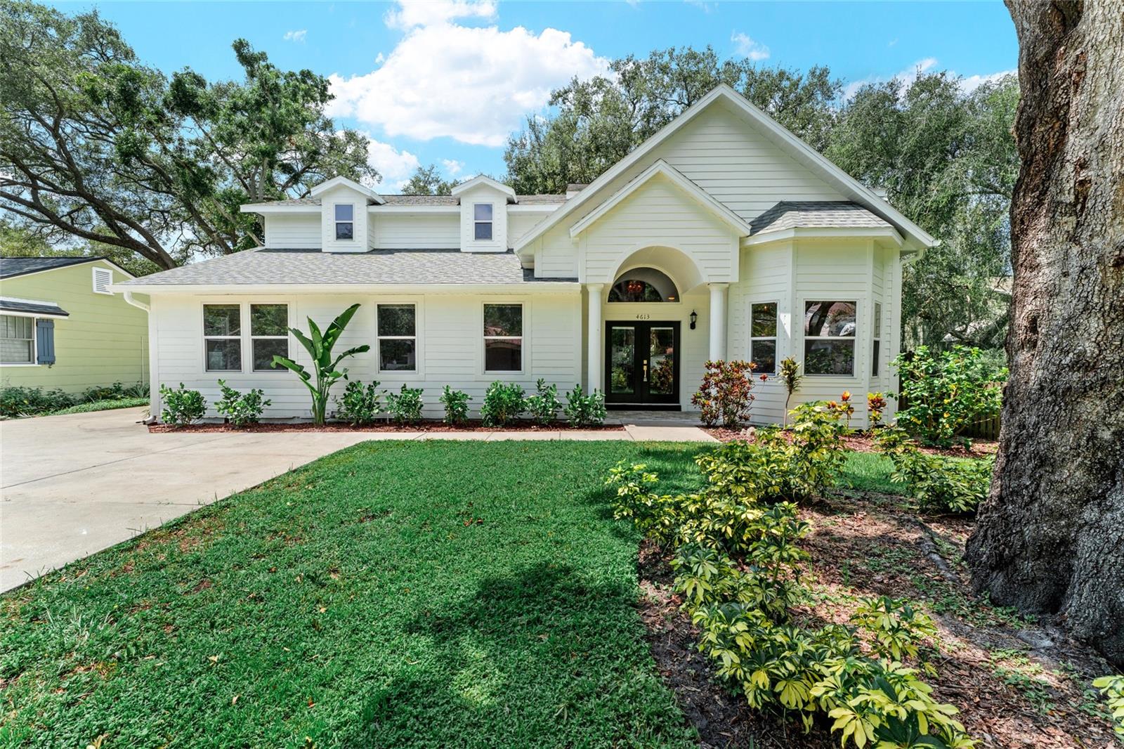 Nestled in the heart of highly sought-after Bayshore Beautiful neighborhood, this expansive South Tampa residence spans over 3,200 sq ft on a generous 70x120 lot, offering both privacy and presence in a premier location. Open the elegant double glass doors to be greeted by soaring cathedral ceilings, rich hardwood flooring and an abundance of natural light. The open layout offers multiple living and dining areas, perfect for both entertaining and everyday comfort. Thoughtfully updated throughout, this residence blends timeless charm and fresh designer finishes. The updated kitchen is open to all of the living spaces, has quartz countertops and backsplash, real wood cabinetry, ss appliances and bronze hardware. All bedrooms are located on the first floor with split floor plan. Primary bedroom has french doors giving you access to screened in back porch, double walk in closets, ensuite bathroom with private water closet, linen closet, massive shower and double vanity. Secondary bedroom has updated ensuite bathroom and ample closet space. Bedroom 3 & 4 are spacious and in close proximity to the updated 3rd bathroom. Upstairs offers an additional loft with private insulated room that can be used as home theatre, 2nd home office, workout room, playroom, library, (easy convert to 5th bedroom), etc. Your imagination is the limit! Outside, enjoy a vaulted screened in porch, over looking plenty of backyard space with room for a pool. The exterior construction of the home is cement based Hardie board siding to resist moisture and pests. Originally built in 1943, home was completely rebuilt in 2001, and beautifully updated 2020-2025. This special home is only a few blocks from Bayshore Boulevard, offering easy access to scenic waterfront paths, parks, award winning restaurants and boutique shopping. Call to schedule your private tour of this truly special property.
