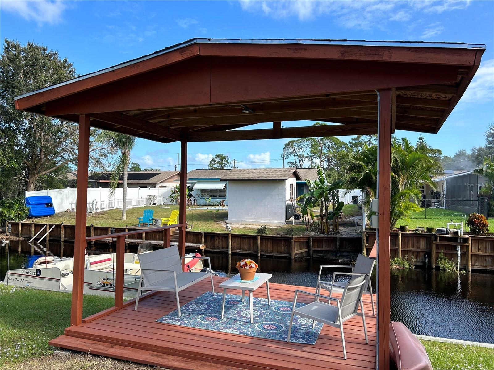 Absolutely adorable Spanish-style Canal home with direct access to Lake Clay -- a sandy-bottom, spring-fed lake EXCELLENT for boating, fishing, and water sports with two public boat ramps and clear, refreshing water year-round (The front of the home faces Lake Clay, offering beautiful sunrise and sunset views!!).
This CBS 3-bedroom, 2-bath home has a separate MOTHER IN LAW apartment with kitchenette and full bath— a dream for guests or extended family.
The open floor plan flows into a large screened porch with hot tub overlooking the lush backyard, boathouse, and canal. Outdoor features include a fireplace, sitting area, and workshop—designed for entertaining and relaxing in your private waterfront oasis.