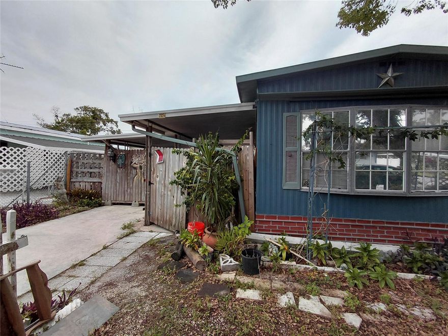 Rare opportunity - Own your mobile own the land with NO HOA. Unique property with extra storage and enclosed porches, ready for you to make it your own! Enjoy full freedom, and very low utilities, low taxes, no age restrictions, No land lease. Enjoy privacy with your fully fenced yard with large double carport and extra storage features including a "she-shed" and small tiki bar on the back side of the carport with built in storage. Not in a Flood zone! Make the double carport with extra storage your outdoor grilling area! Make this your own, there are many possibilities! Extra rooms can be an office or gym, or extra bedrooms. Newer plumbing, Newer mini split A/C, metal roof has been coated. Very convenient to schools, shopping, dining, hospitals, and the historic Tarpon Springs Sponge Docks. Plus, enjoy an easy commute to both Pinellas and Tampa Airport