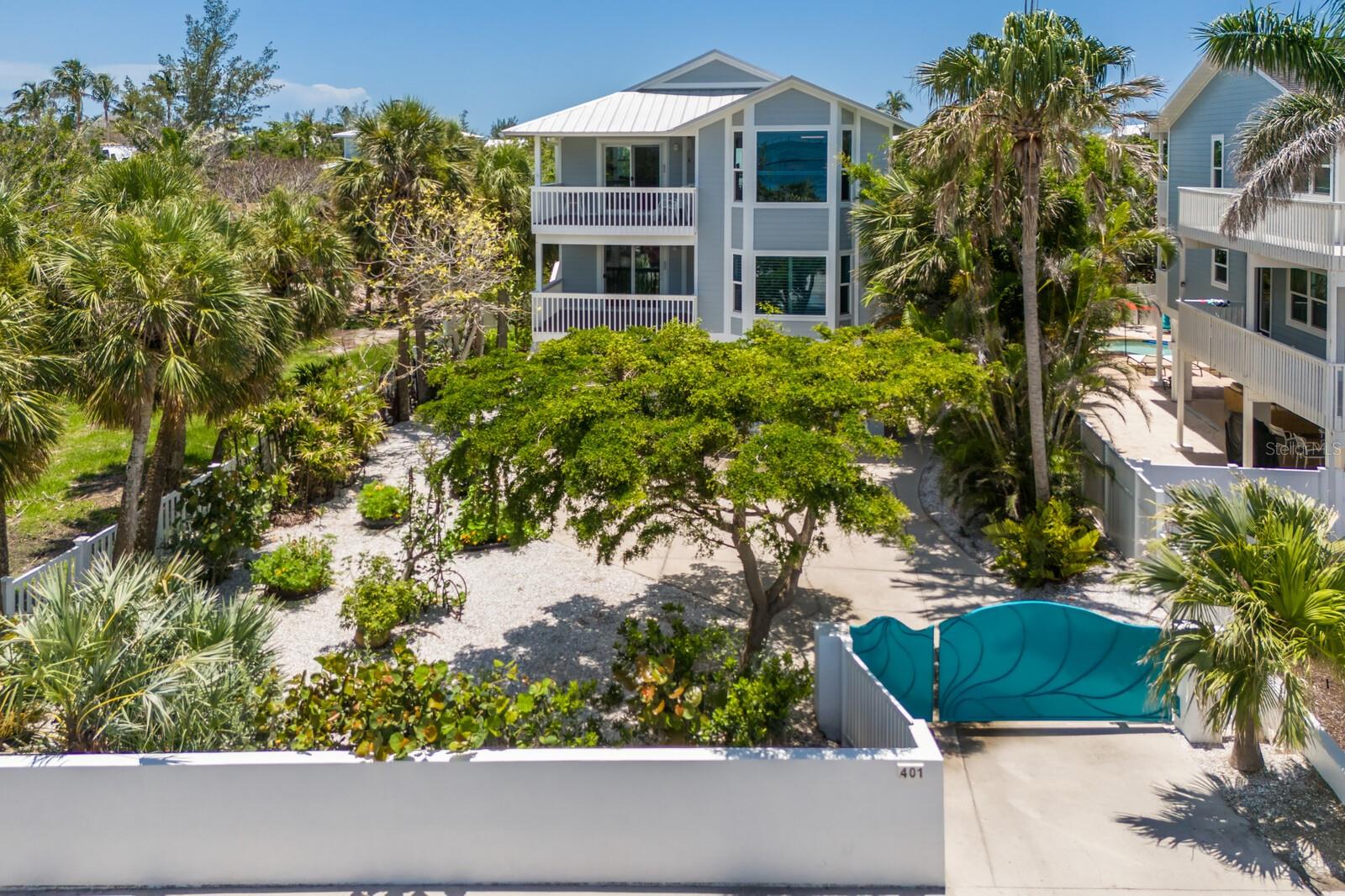 Perfectly positioned just steps from the sparkling turquoise waters of Tampa Bay, this elevated island home offers breathtaking views of the iconic Skyway Bridge and a front-row seat to the beauty of Anna Maria's coastal charm. Inside, the home showcases a flexible layout with two bedrooms and two and a half baths, along with a bonus/office which is a clear opportunity to create a third bedroom if desired. The top level is thoughtfully designed for entertaining, with the kitchen, living, and dining areas all oriented to maximize the stunning water views and natural light. The kitchen is both stylish and functional, featuring elegant granite countertops that enhance the open and welcoming layout. Sweeping water views and palm tree lined vistas create a true island oasis from so many vantage points throughout the home. There is a covered deck off the living area to create even more open living space as well as rear decks off both levels. A new metal roof, impact windows & doors, hardie board siding, Azak stairs & decking with PVC railings add peace of mind and long-term value. Surrounded by lush, mature landscaping, the property provides a sense of privacy and tranquility, featuring a gated driveway and a spacious three car garage complete with a dedicated workshop, ideal for hobbyists or for storing all the water toys and beach gear. There is room for a pool in the front corner of the property too! Whether you are relaxing on the balcony or taking in the gentle coastal breeze, this home captures the essence of laid back luxury in one of Anna Maria’s most desirable locations. With short-term vacation rentals permitted, it presents excellent income potential while also offering the comfort and charm to serve as your forever home. Don’t miss out on this perfect slice of island life!