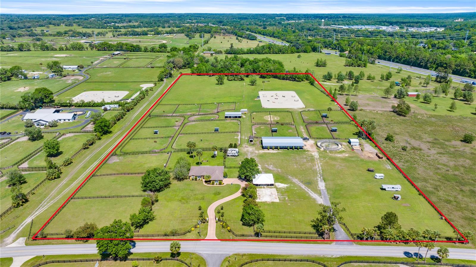 Under contract-accepting backup offers. Located in the heart of Ocala, Florida's renowned horse country, this stunning 20-acre show jumping farm offers the perfect blend of functionality and comfort. Located just 8.5 miles from the World Equestrian Center (WEC), this property is a dream come true for equestrian enthusiasts. The centerpiece of the farm is a state-of-the-art 150x260 Eb and Flow arena, designed to provide an exceptional training and competition experience. The meticulously maintained barns with 24 stalls ensures ample space for your horses, while the recently updated fencing around 21 paddocks and round pen enhances both safety and aesthetics across the expansive grounds.
The charming 3-bedroom, 2-bathroom home offers a cozy retreat after a day in the saddle, featuring modern amenities and plenty of natural light. With 20 acres of lush, rolling land, this property provides endless opportunities for riding, training, and enjoying the serene beauty of Ocala. Whether you're a professional rider or simply passionate about the equestrian lifestyle, this turnkey farm is an unparalleled opportunity in one of the nation's premier horse communities.