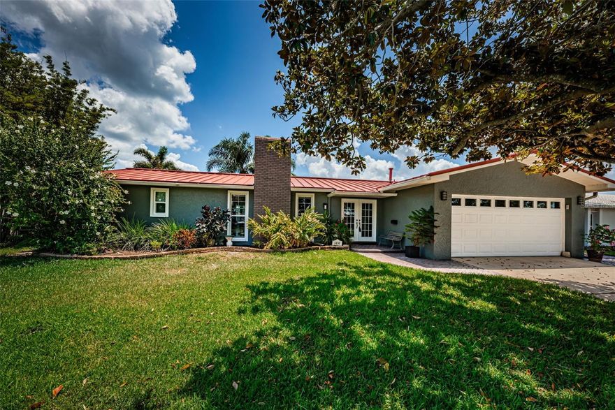 Waterfront living with a pool, dock, and boat lift! This beautifully maintained 3-bedroom, 2-bath home offers an inviting layout with flow between the kitchen, dining, and family room, plus a separate living room. Both bathrooms have been tastefully updated, and the refreshed wood-burning fireplace creates a warm focal point in the living space.

Major improvements include a brand-new HVAC system with all new ductwork, a durable metal roof, updated canned lighting and a tankless water heater installed in 2025. Outside, enjoy Florida living at its best with a resurfaced and retiled pool, updated pool pump, outdoor shower, and a convenient doggie door through the pool cage. Boaters will appreciate the 10,000lb boat lift and updated seawall. The backyard also features a covered, paver entertaining area with solid stone countertops already in place — ideal for creating a future outdoor kitchen.

Additional highlights include Roll-A-Guard mesh hurricane protection for the front windows and door, plus an EV charger in the garage.

This home is located in a wonderful, central area. Nearby is the brand new Shore Acres Recreation Center with public classes and a huge pool. This is a true neighborhood: golf cart-friendly streets & neighborhood gatherings in nearby Denver Park. St. Petersburg offers world-class dining, the Dalí Museum, the St. Pete Pier, craft breweries, & much more, Two airports and waterfront parks are just a short drive away. This move-in ready waterfront retreat blends comfort, thoughtful upgrades, and the best of indoor-outdoor Florida living.