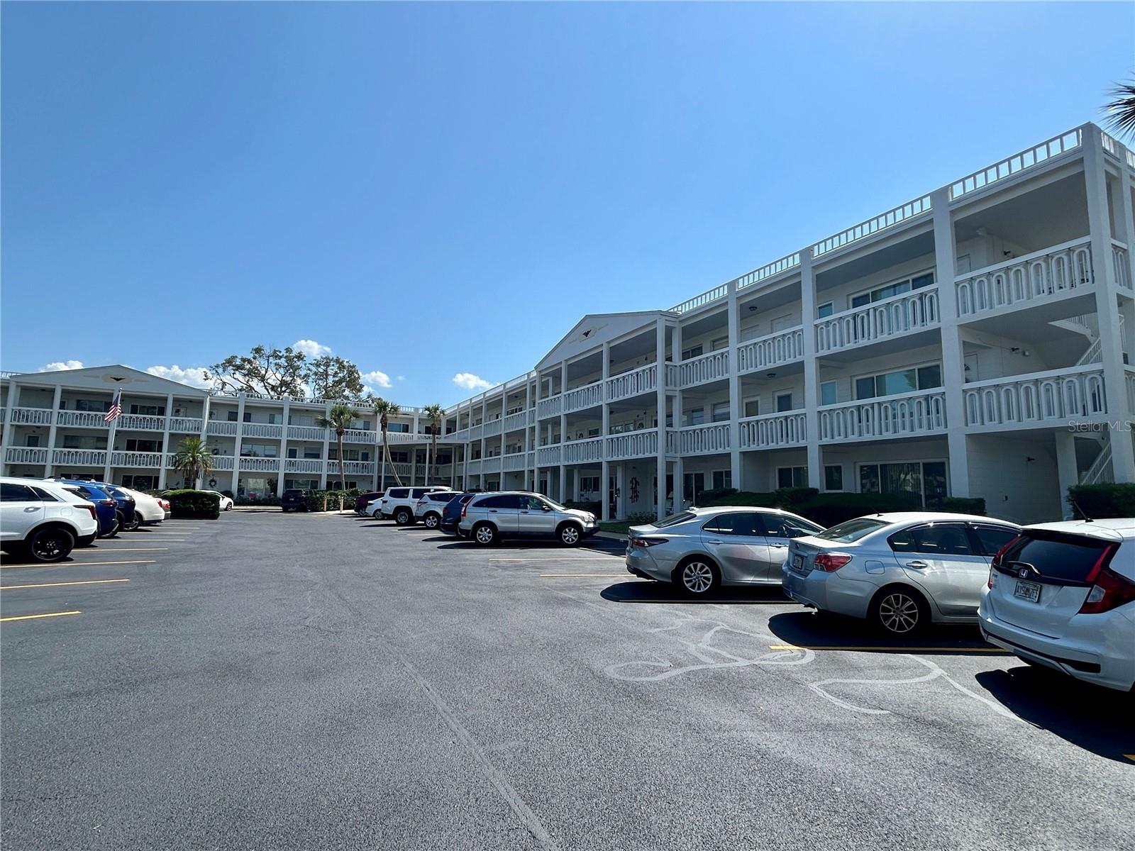 Welcome to your meticulously updated and furnished 2 bed, 1 bath oasis, ideally located on the first floor and just across the street from the East Activity Center. You will have convenient access to a wealth of amenities including a heated swimming pool, modern fitness center, tennis and pickleball courts, all within walking distance. Park in your assigned parking spot right outside your front door and step inside where you will be greeted by beautiful luxury vinyl plank flooring throughout the unit. The renovated kitchen features updated and extended cabinetry, newer stainless-steel appliances, a chic ceramic tile backsplash, and recessed lighting. This kitchen is a true delight for any home chef. Key updates ensure your comfort and convenience for years to come, including the windows, front and rear doors, ceiling fans. The bathroom has been tastefully updated, featuring new wall and floor tile, glass shower doors, a comfort-height commode, vanity, faucet and lighting, offering a blend of style and functionality. The extra-large living room includes a remote-controlled front window shade. The electric circuit panel and been replaced, and the AC in 2018 and water heater in 2015. This vibrant 55+ community offers an array of amenities designed to enhance your lifestyle. Enjoy exclusive access to two private golf courses with 9 and 18 holes, two heated swimming pools, and two activity centers. Stay fit with the remodeled Cardio Gym, equipped with the latest exercise equipment, or participate in various community activities such as fitness classes, dancing, clubs, cards, billiards, and more. Pet owners will appreciate the very pet-friendly environment, complete with a fenced dog park and covered seating. The community also offers hobby studios and a woodshop for the exclusive use of residents. The on-site Good Karma Café provides convenient "take & bake" meals and snacks. Located close to beaches, transportation, shopping, entertainment, and fine dining, this condo combines convenience with comfort. All room sizes, floor plans, and square footage are approximate. This property is being transferred by a fee simple deed (no land lease), and association approval is required. If financing, a 35% down payment is required. Don't miss out on this fantastic opportunity to own a contemporary condo in a prime location, offering an exceptional lifestyle and easy access to a range of amenities. Schedule your showing today.