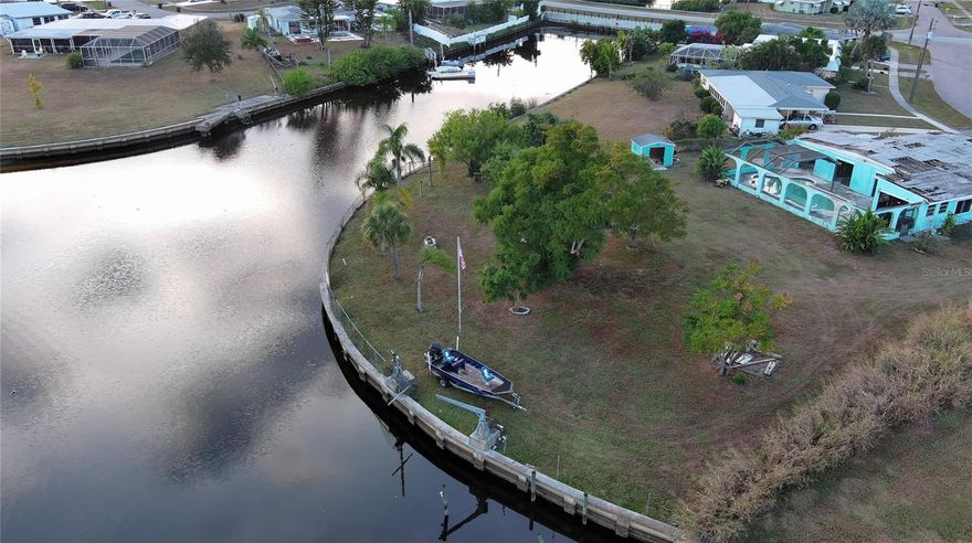 Discover an exceptional opportunity to build your dream home on this spacious 0.57-acre waterfront lot in a prime North Port location. The property includes an existing uninhabitable structure, giving you a clean slate to design and create a home that truly reflects your vision.
With approximately 200 square feet of seawall, the lot provides direct canal access, ideal for boating, kayaking, fishing, or simply enjoying the tranquil water views from your backyard. The generous dimensions offer ample flexibility in your build, ensuring you can create a residence without compromise, complete with an unmatched waterfront outlook. The property is further enhanced by mature fruit trees, adding natural beauty and the welcoming charm of an established Florida landscape. Two boat davit cranes are also on-site and may be revitalized with some maintenance, giving boaters an added advantage. Convenience meets serenity here: you're just minutes from Gulf beaches, golf courses, parks, and the iconic Warm Mineral Springs. Shopping, dining, and essential services, are all nearby. Gulf access is a breeze via the Big Slough leading to the Myakka River, opening the door to endless coastal adventures. With its rare size, waterfront setting, existing utilities, and unbeatable location, this lot offers all the right conditions for a successful and rewarding build. All information is deemed reliable but not guaranteed; buyers and buyer’s agents should verify all details.