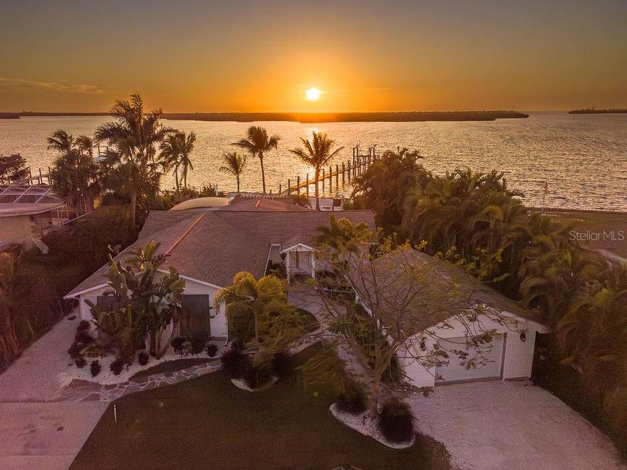 Welcome to a modern coastal paradise, hidden on idyllic Terra Ceia Island! Over a quarter acre along the aquatic preserve of Miguel Bay, this home offers endless entertainment with an open floor plan and fully updated modern aesthetic, surrounded by a tropical setting, fiery sunsets, and views of the Skyway Bridge. The property doubles as a wonderful investment opportunity with no HOA or leasing restrictions, providing not just a short-term rental but a true Old Florida experience, where Captains bring their charters for World Class inshore fishing, only a few minutes to open Gulf waters.
Relaxation awaits in this 4-bedroom, 2.5 bath beautifully updated custom coastal residence, intended to complement its serene surroundings with water views from nearly every room. The thoughtfully designed split floor plan offers privacy and flexibility with a master suite featuring a discrete entrance off the lush courtyard with multiple cedar closets & custom built-ins. The second bedroom boasts an ensuite with a bathtub creating a welcoming space for any guest. The third bedroom features a private covered patio. The fourth bedroom, currently utilized as a nursery, could easily serve as a home office or hobby room. Each bathroom has been carefully updated with custom vanities and travertine tile. An oversized utility room featuring an icemaker offers easy storage and accessibility for the fisherman on the go!
Warm wood-beamed ceilings, elegant Leonardo Travertine in Versailles pattern, Sunset quartz countertops, in a central, open kitchen, create an inviting, sophisticated atmosphere. The fully updated Chef’s kitchen is the heart of the home, with an oversized island, seamlessly connects the family room with the outdoors, all overlooking Miguel Bay. Samsung Bespoke White Glass Kitchen Suite of appliances offer top of the line features such as a gas stove with Air Sous Vide, French Door Refrigerator with custom ice settings, and wifi enabled microwave.
Venture out of the luxurious interior into one of the many outdoor living areas, and enjoy stargazing in the tropical courtyard or cocktails fireside after a long day of boating. You will be greeted by all that nature has to offer, from Manatees, dolphins, tarpon, white pelicans, and roseate spoonbills. A 165-foot dock, built with durable Trex decking, comes equipped with water, power, a 10,000-pound boat lift with remote, and stairs leading down for an easy kayak launch. The meticulous grounds feature winding stone paths under the canopy of a Royal Poinciana, “The Lido Deck” pergola, charming shell beach under swaying Coconut, Bottle, Areca Palms, all surrounded by mature Florida landscaping.
For those fortunate enough to enjoy, historic Terra Ceia Island is more than just a location—it's a lifestyle. This close-knit active community comes together for events like the Mullet Festival, Kayak Poker Regatta, Halloween Hayrides, Around the World Dinner, Easter Egg Hunt, and a Christmas Golf Cart Parade. The optional Village Improvement Association provides access to the community hall and waterfront Seabreeze Park, complete with picnic pavilions, boat ramp, a soon to be built 300 ft fishing pier, playground & pickleball courts. Conveniently situated at the foot of the Sunshine Skyway Bridge, Terra Ceia offers easy commute and access to St. Pete Beach, Tampa, Anna Maria Island, and Bradenton. Unwind and experience Old Florida living at this one-of-a-kind luxury waterfront property.