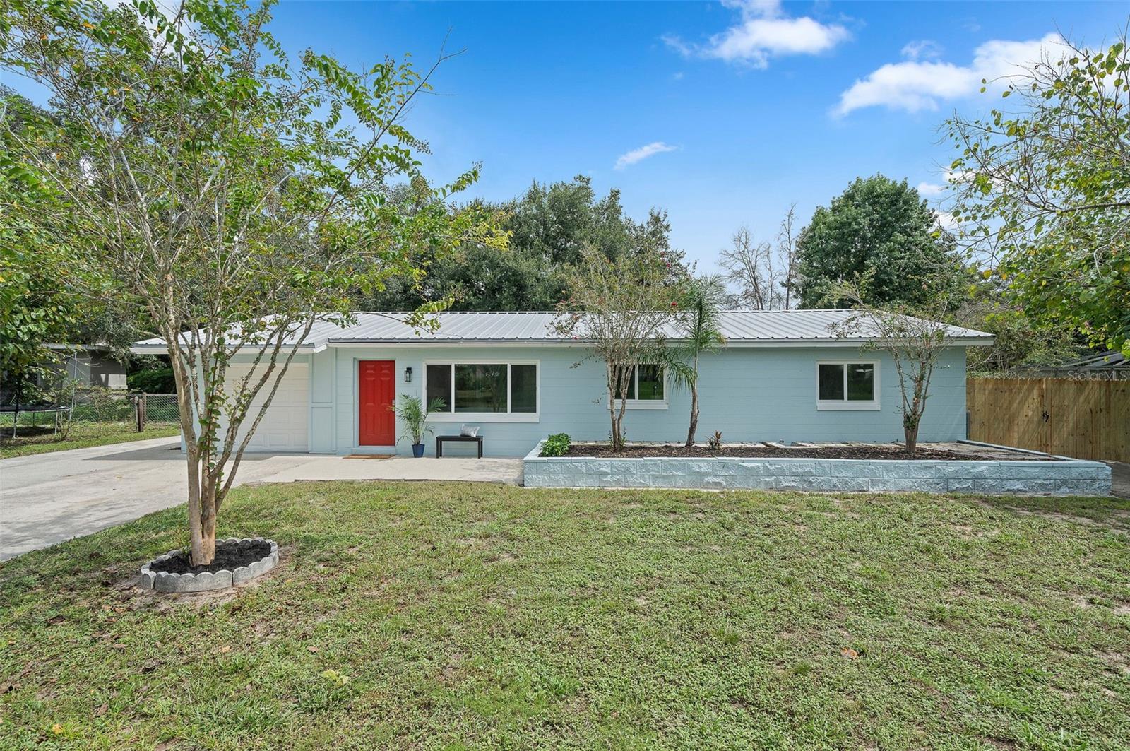 Completely remodeled and move-in ready, this charming 3-bedroom, 2-bathroom home in Dade City combines modern luxury with everyday comfort. Inside, the fully furnished interior welcomes you with an airy, open layout and stylish finishes throughout. The kitchen is a true centerpiece, featuring quartz countertops, Frigidaire stainless steel appliances, soft-close wood cabinets, a pot filler, and a large breakfast bar, perfect for casual meals. A dry bar with additional cabinetry sits just across from the kitchen, adding both function and flair. Natural light pours into the dining area, offering views of the spacious backyard, while the living room with its large front window creates a bright, inviting space to relax or entertain.
The private owner’s suite is tucked away at the rear of the home, complete with a beautifully remodeled en-suite bath. Two additional bedrooms provide generous space and ample storage, while the updated guest bath features spa-like finishes. Outdoors, enjoy the expansive fenced backyard with a paver patio, ideal for gatherings, play, or simply unwinding.
UPDATES INCLUDE: 2022 impact windows, 2013 metal roof, 2025 Tankless Water Heater, 2025 Electric Panel, all new electric wiring, new luxury vinyl plank flooring through-out, custom kitchen renovation including Frigidaire Stainless Steel Appliances, quartz counters, soft-close wood cabinets, upgraded lighting, remodeled bathrooms with custom tile, new vanities, fixtures, and toilets, fresh interior and exterior paint, 5” baseboards, new interior doors and hardware, recessed lighting, open air paver patio, 2025 wood fencing with double gates, and much more! With no HOA or CDD, bring your boat or RV! Home offers easy access to I-75, close to parks, trails, golf, restaurants, hospitals, and shopping, while still offering the peace and charm of Dade City living.
Schedule your private showing today and fall in love with this turnkey gem!