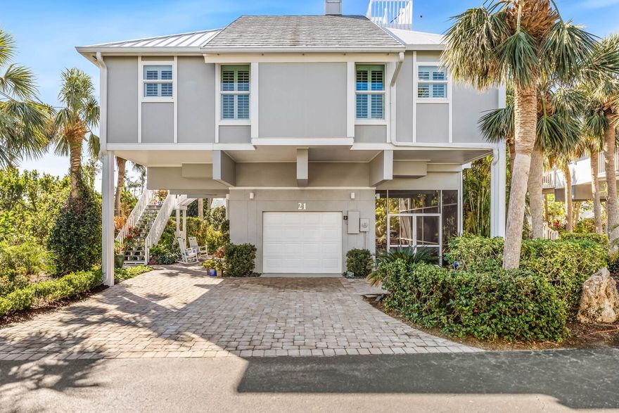 This elevated single family residence, with elevator, offers ample space for family and friends with 3 bedrooms, 3 full bathrooms and a Bunk room. The beautifully updated interior features an enlarged kitchen with oversized island and high end appliances, including gas range, a dedicated laundry room with great storage, newly updated bathrooms, and beautiful flooring thru out.  Enjoy cocktail hour from your additional elevated viewing deck while enjoying the stunning gulf and bay views. Additional exterior updates include cement board siding, impact glass, newer a/c units, and maintenance free decking. The lower level provides a private single car garage, serene garden area with patio and large wrap around screened in lanai. Located within the private Boca Grande Club community and only a short walk to the beach where the crystal blue waters of the Gulf of Mexico await you. This home is in pristine condition and will please even the most discerning Buyer.