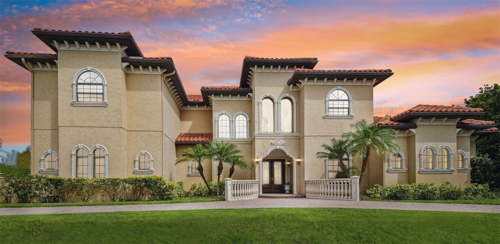 Villa Paradiso, a rare opportunity in Avila. At the end of a quiet cul-de-sac inside Avila Golf & Country Club, Tampa Bay's most exclusive 24/7 guard-gated community, Villa Paradiso is a masterpiece of refined luxury, superior craftsmanship and impeccable construction. A grand circular driveway leads to this Mediterranean estate, where double doors and a graceful double-height foyer create an unforgettable first impression. Polished marble floors reflect natural light beautifully, while intricate trim work, tray and coffered ceilings, elegant arches, and hand-carved stone columns add depth and sophistication. The formal living room, anchored by a majestic fireplace, offers stunning views of the pool and grand foyer. A full bar with a wine cellar flows seamlessly into the dining room, making it ideal for entertaining, with a nearby powder room for guests. Designed for grandeur and comfort, the home features an elevator, a formal staircase and a secondary back staircase for convenience. The primary suite, on the main level, overlooks the lush green preserve, offering a serene retreat. Its spa-like, all-marble bath boasts an oversized shower and exquisite finishes. A second bedroom with en suite is also on the first floor, ideal for guests or multi-generational living. Each of the six bedrooms includes its private full bath, ensuring privacy and comfort, complemented by a full pool bath. The kitchen and family room feature breathtaking conservation views, with French doors opening to the resort-style pool, creating an ideal space for entertaining and relaxation. A separate office and a game room with a wet bar complete this exceptional home. Villa Paradiso is a rare offering so don't miss this opportunity to make it yours.