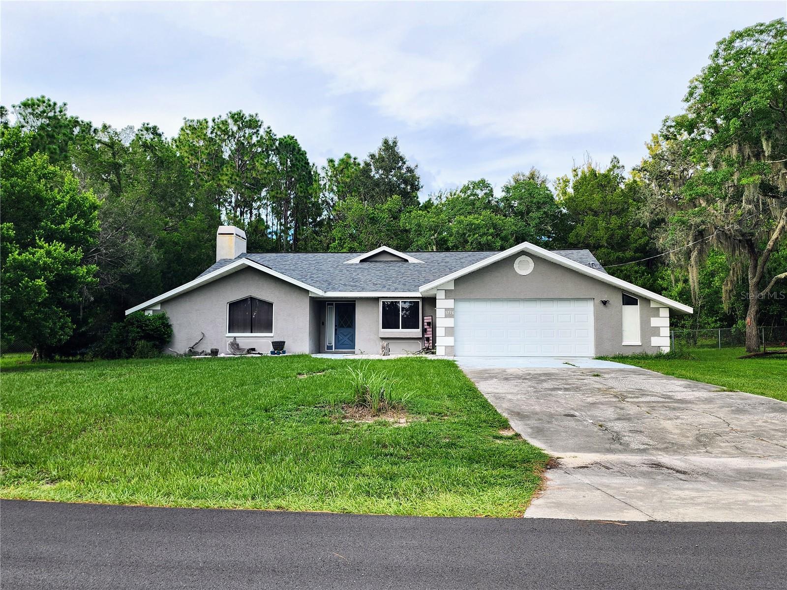 Welcome to this beautiful 4 bedroom 2 bathroom home that sits on over a half acre that is fully fenced. This concrete block home comes with a 5 year old roof and new outside painting. This home has new floors and a new kitchen and brand new master bathroom, the water heater and HVAC are 2015 and the HVAC is serviced yearly. The shed stays with the home and you can bring your toys with No HOA and side access to your back yard on a corner lot. The wood burning fireplace is the focal point of the home when you walk in and leads to the new kitchen and out to the large back yard with firepit, this home is ready for new owners to call home.