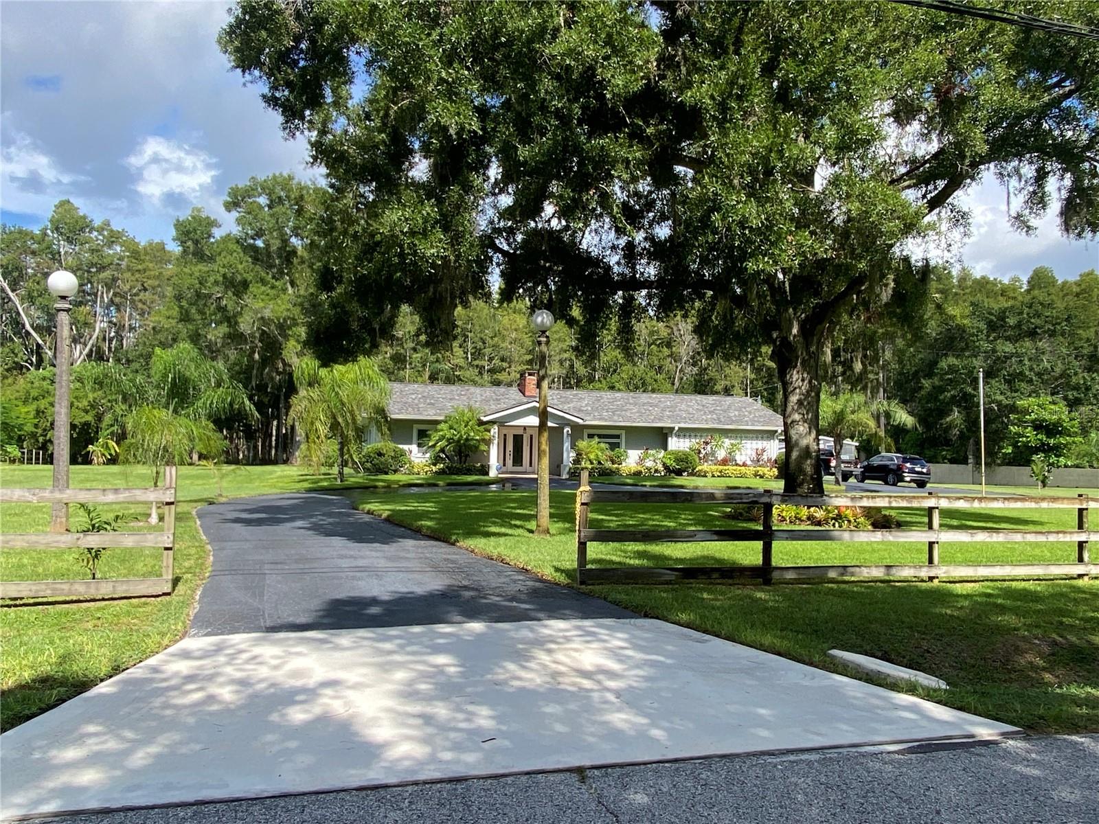 Amazing home that has been meticulously maintained and updated throughout. This is a non-deed restricted neighborhood with the feel of the country, but near the heart of Tampa. It is in a non flood zone - "X". A couple minutes away from the Suncoast Parkway, gets you to Tampa Airport in about 20 minutes and in about 45 minutes you can be enjoying the beach. There are 2 primary suites with full private baths, plus a 3rd bedroom and a 3rd full bath. The cozy and inviting foyer welcomes you upon entering the front door, and the formal living room with a wood burning fireplace adds to the ambiance and comfort of the home. There is a formal dining area with built in cabinets and an extra large Florida Sunroom overlooking the backyard that hosts various wildlife, such as deer, turkeys and a variety of birds. There is travertine tile throughout and a large indoor laundry room with pantry shelving. The updated kitchen has wood cabinetry with slow glide doors and roll out drawers. The reverse osmosis water system under the kitchen sink offers purified water for drinking and cooking. The kitchen also has track lighting, tile backsplash and beautiful quartz counter tops. You can be at ease with all the updates and routine maintenance done with this property. The 3.5 ton, 15 Seer York AC was purchased in 2021, the roof replaced in 2020 with 30 year shingles and the hot water heater replaced in 2025. The windows were all replaced in 2013 with modern high efficiency glass that can swivel inward for easy cleaning of both sides, from inside the home. Transferrable warranty paperwork available on most of the newer items.
As an added BONUS, the detached building was converted into an extra in-law studio/apartment/guest suite during covid. It has a partial kitchen, full bath, plus full-size bed and living area.
The home is on 2.54 acres, backing up to conservation with no rear neighbors in sight and zoned ASC-01 for agriculture. There are mature oaks, a circular drive, fencing, a large storage barn (items in barn do not convey) with paver flooring, running water and electric, a small retention pond, St. Augustine grass in the front sections with a sprinkler system and a covered/screened outdoor patio/picnic area.
Photos were taken while seller was still living in the home and after they moved out, showing both visually, vacant and staged with sellers furnishings.
This home speaks for itself. Great location! Move in ready with everything updated and maintained! Large lot with lots of privacy! We welcome you to come by and find your next home!
All room measurements are estimates and should be confirmed by the buyer's agent. No known lease restrictions, but should be confirmed by buyer's agent.