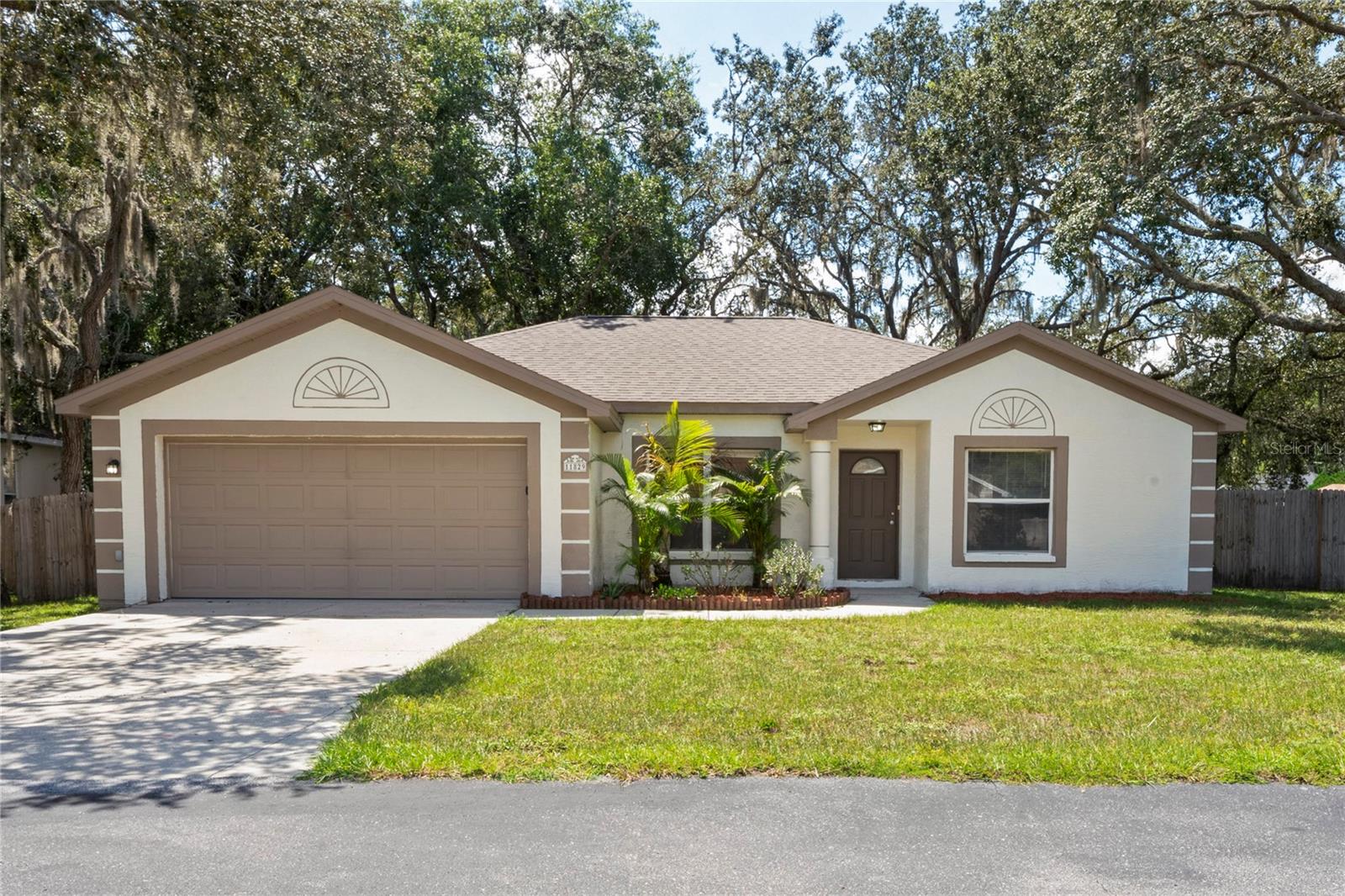 Welcome to 11829 Kestrel Dr! This 3-bedroom, 2-bathroom home in the gated community of Forest Pointe offers nearly 1,400 sq ft of living space and a 2-car garage on a large corner lot. Step inside the foyer to find modern paint and combo of tile flooring and luxury vinyl plank throughout the home. The layout features a dedicated dining area and spacious living room that connect seamlessly to the kitchen—complete with granite countertops and stainless steel appliances. The primary suite boasts a private en-suite bathroom and a walk-in closet, while two additional bedrooms share a full bath. The screened-in lanai provides an excellent escape and easy access to the massive fenced-in backyard featuring beautiful mature oak trees. Conveniently located near schools, shopping, and major roadways. Call to schedule a showing today!